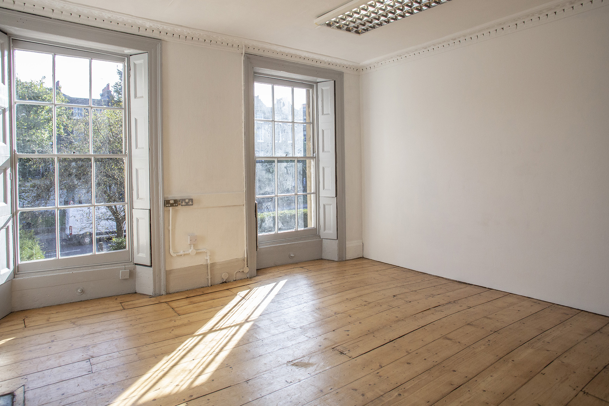 Bright meeting space with large windows, perfect for brainstorming sessions and gatherings.