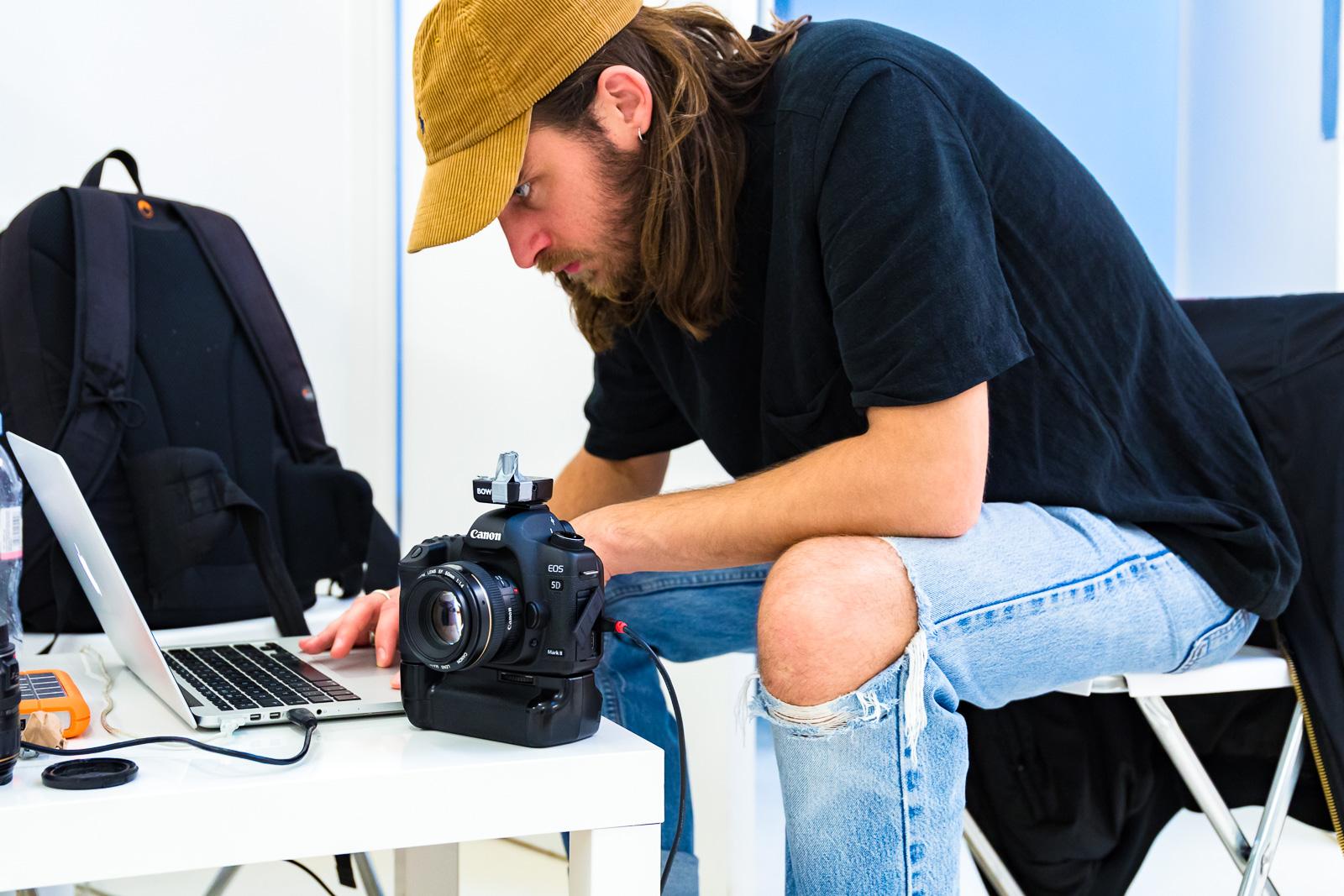 Focused professional editing footage in creative Blankbox Studio for event marketing.