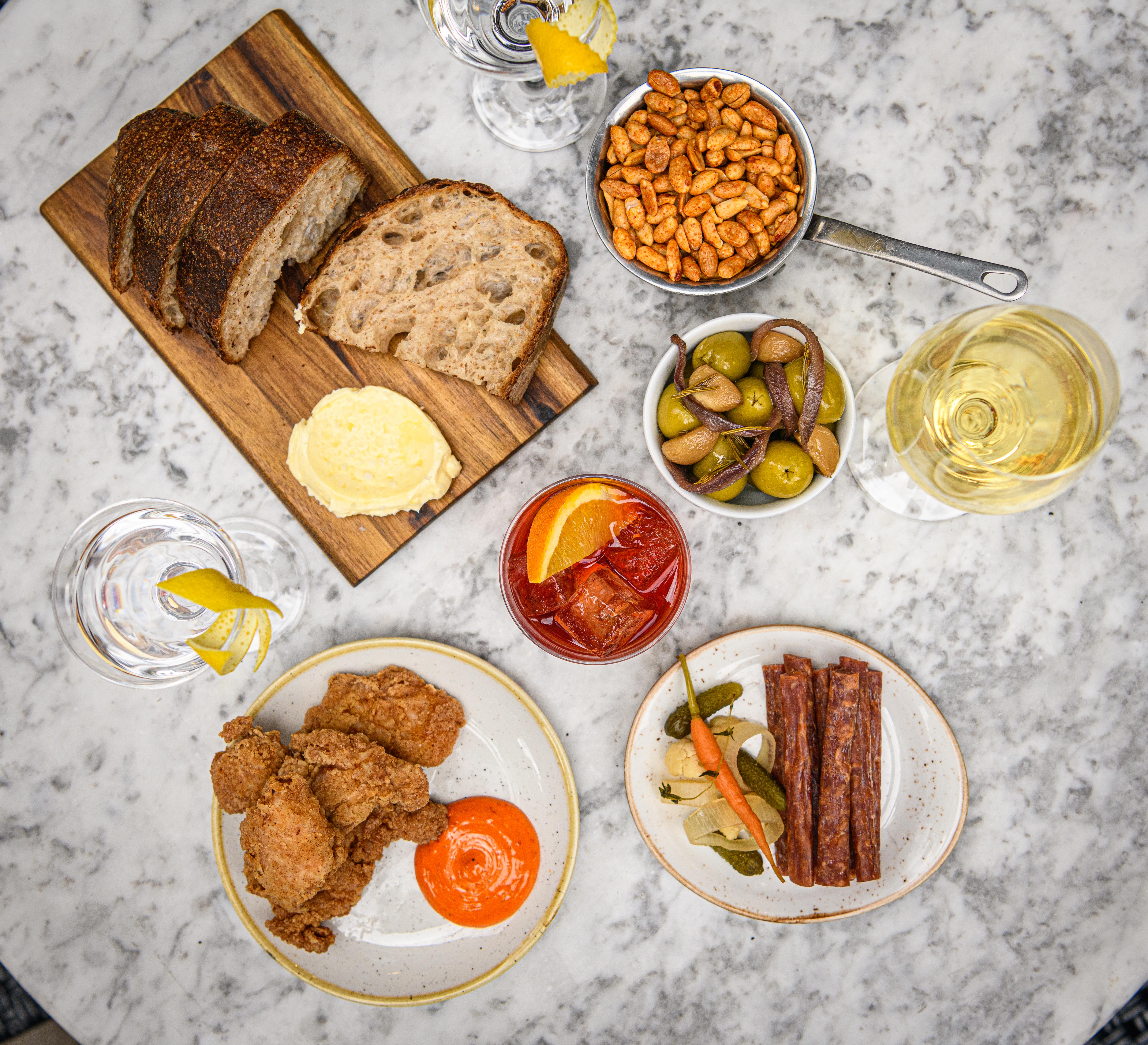 Lounge spread with artisanal bread and cocktails for networking event or casual meeting.