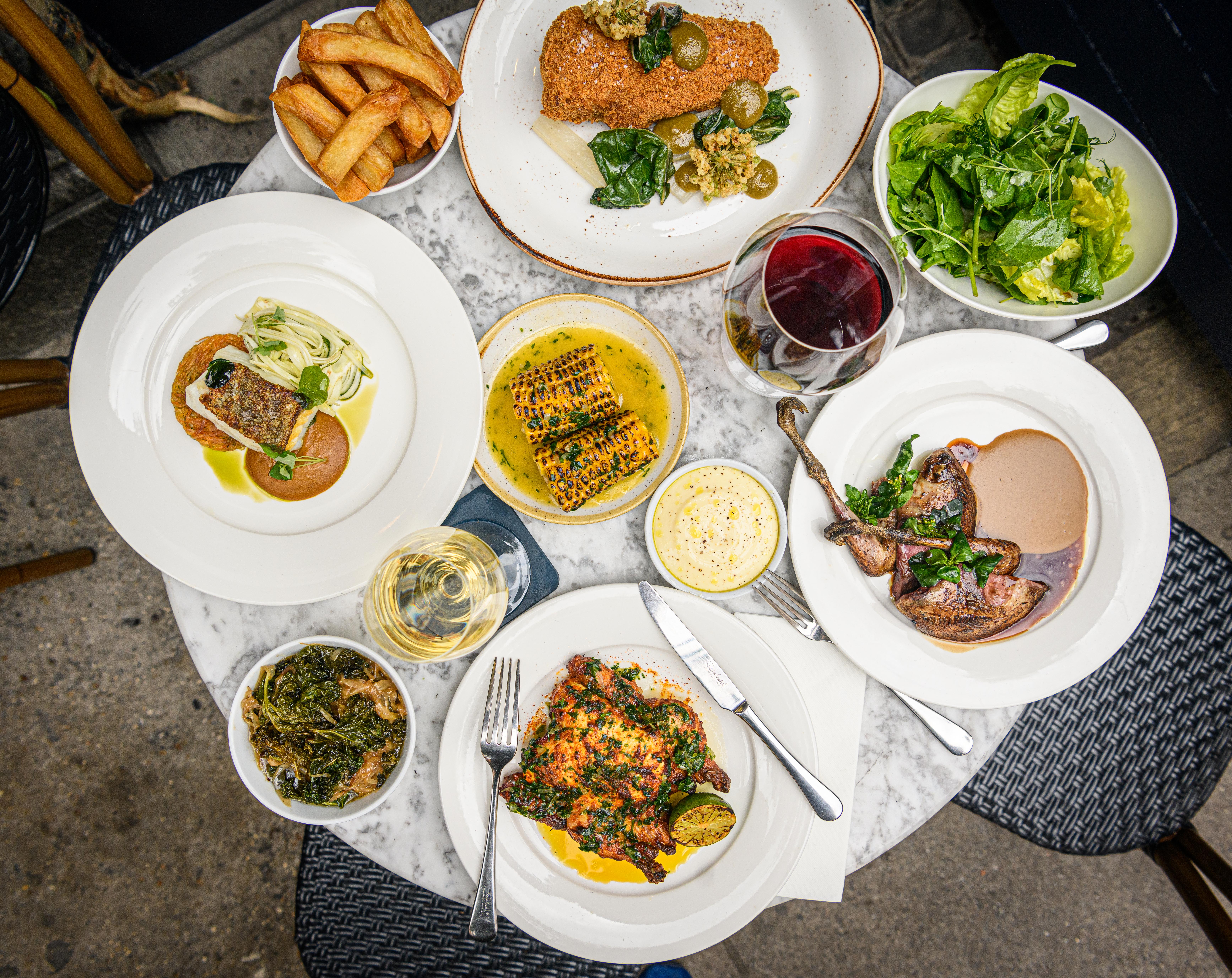 Elegant dining table setup with gourmet dishes for corporate events and gatherings.