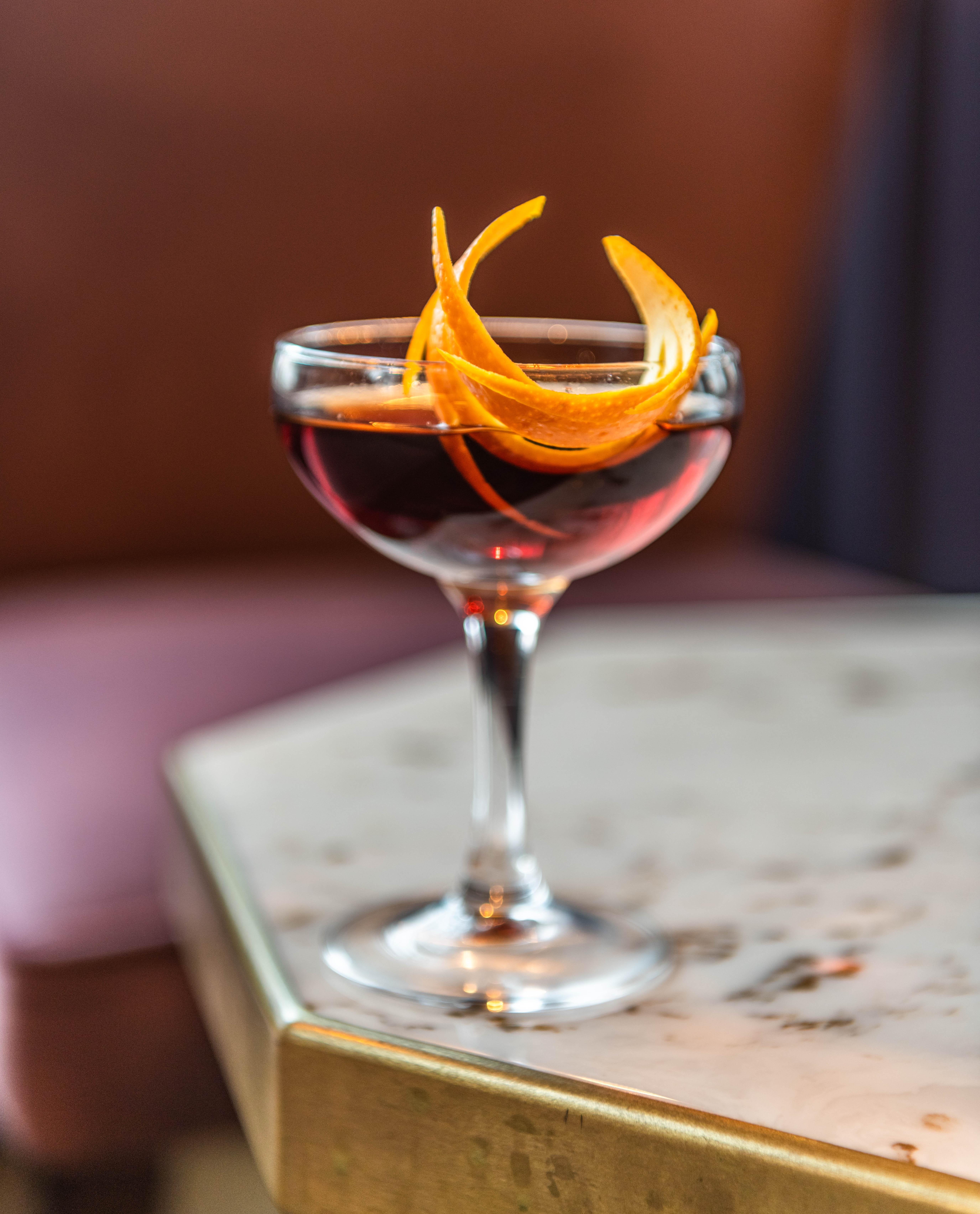 Elegant cocktail with citrus twist at The Lounge, perfect for upscale events and networking.