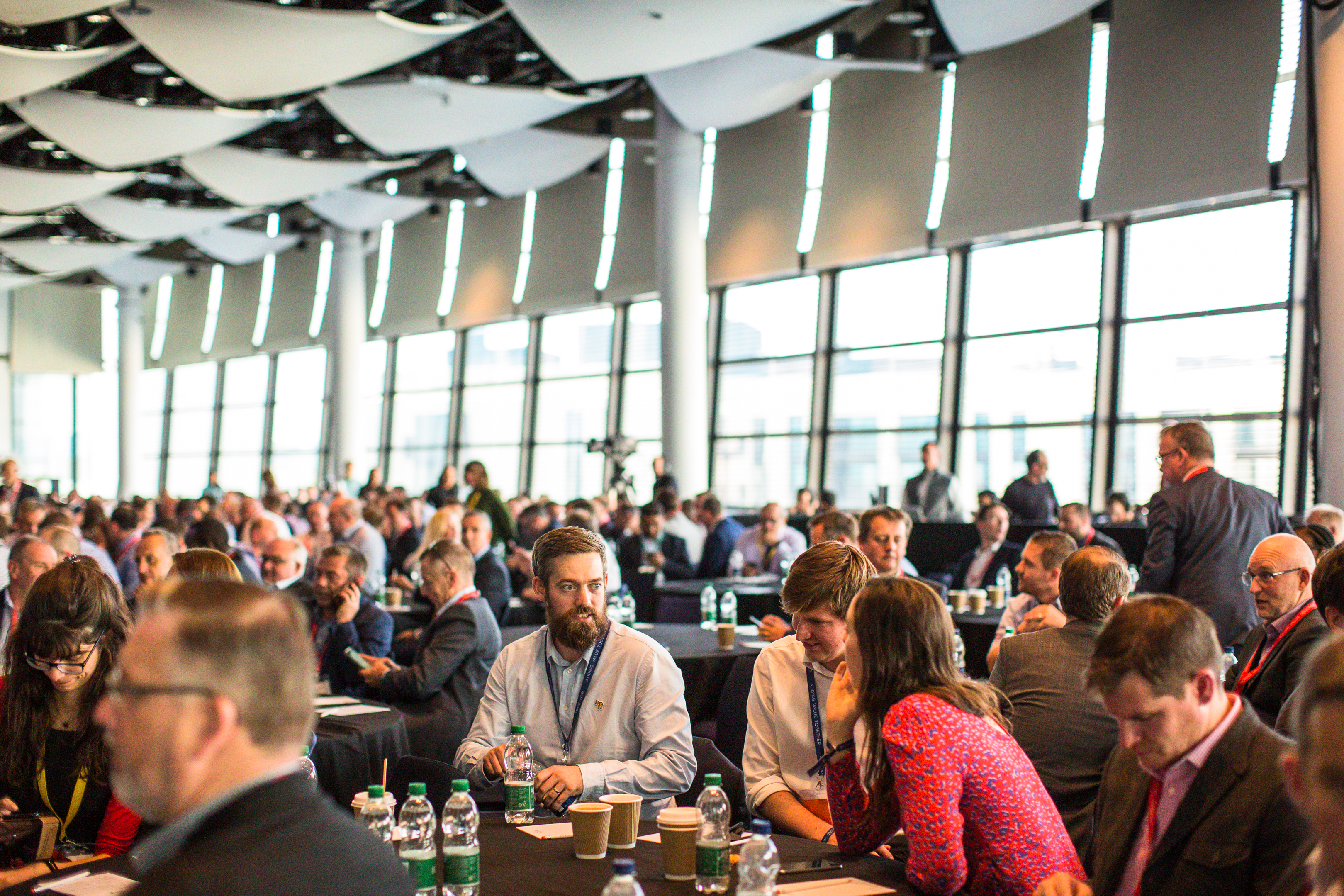 Wembley Stadium Great Hall conference with attendees networking and natural light.