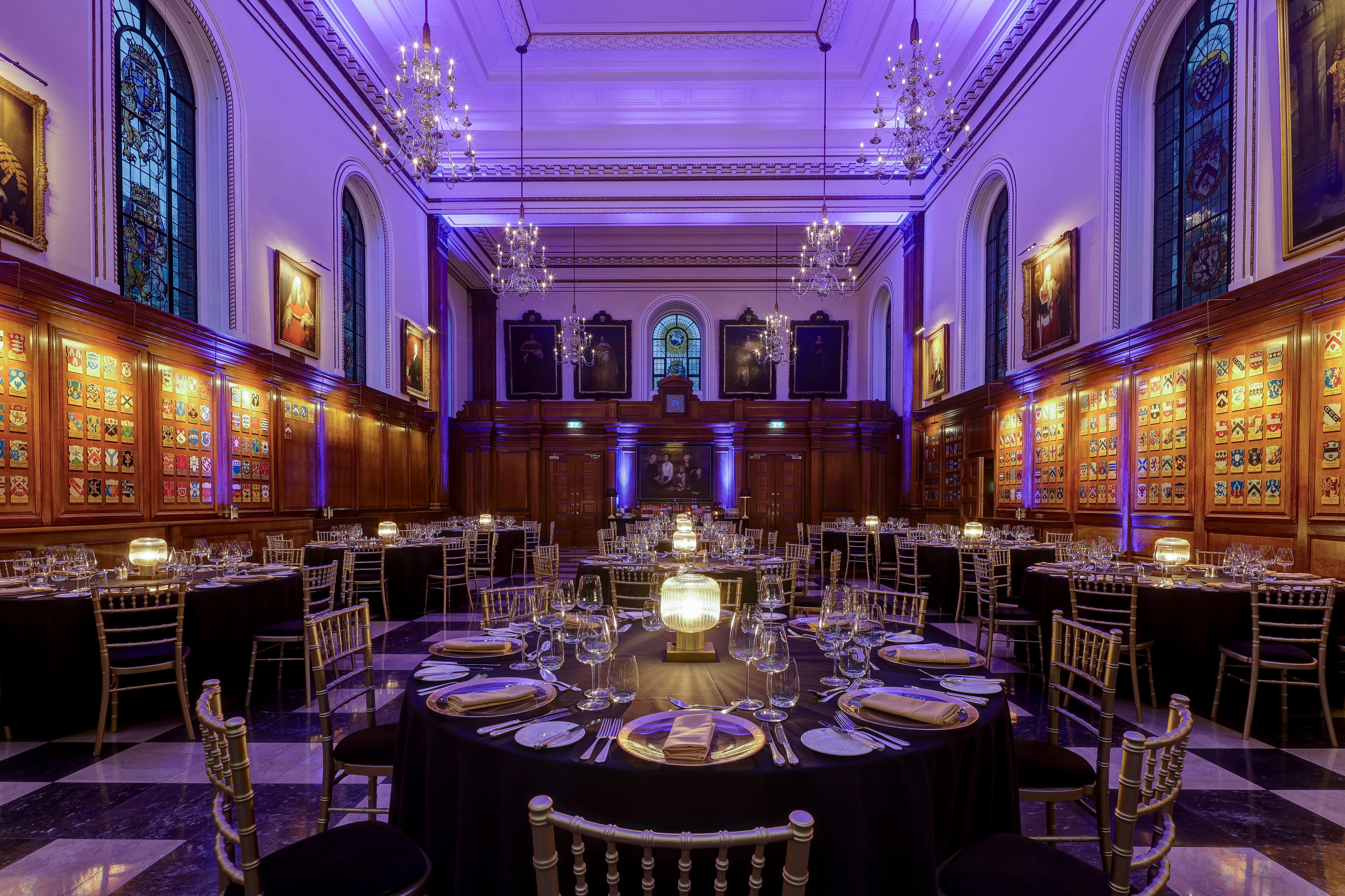 Inner Temple Hall gala with purple uplighting, banquet seating, and elegant decor for corporate events.
