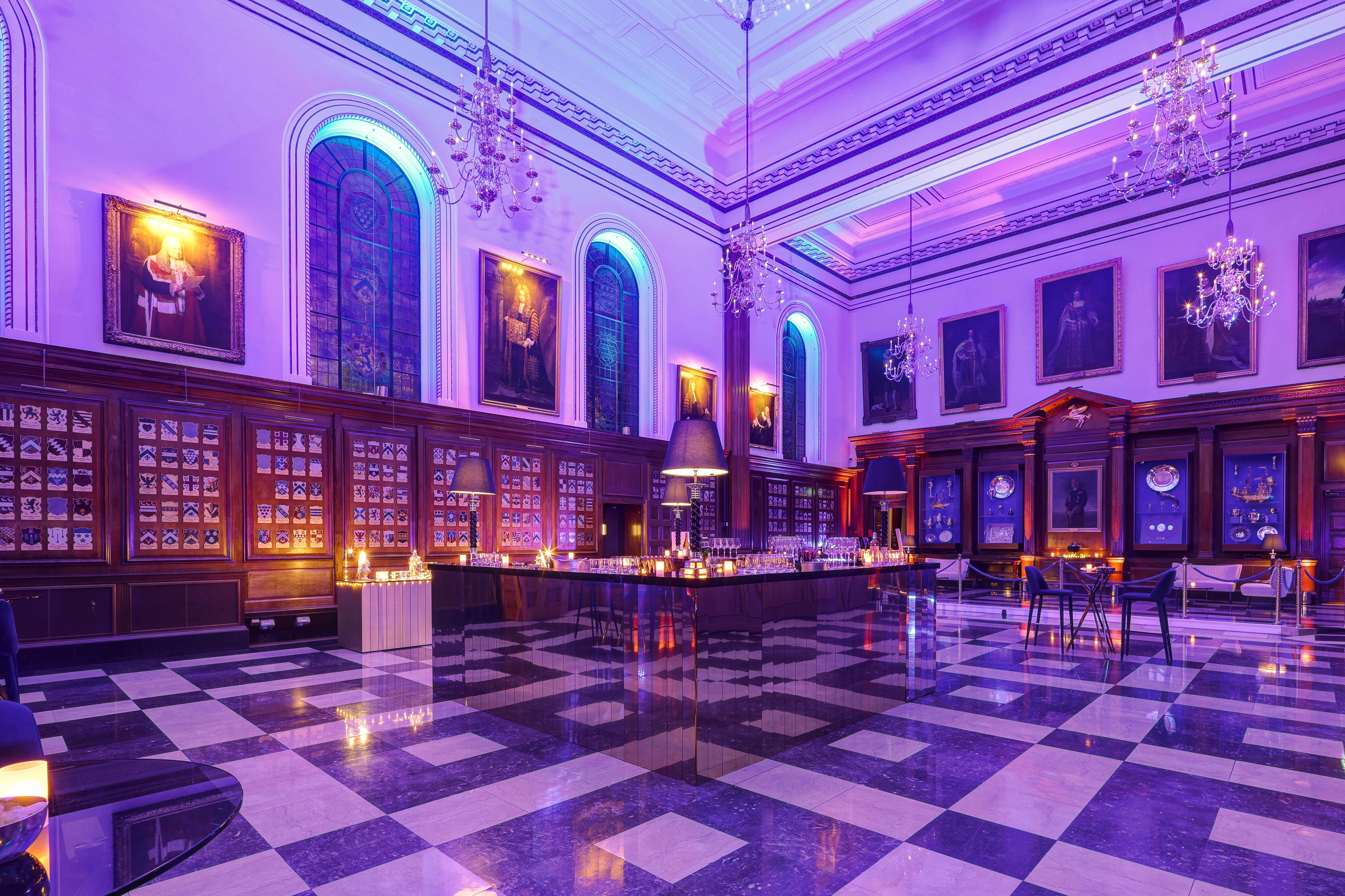 Inner Temple Hall evening reception with purple lighting and mirrored bar for corporate events.