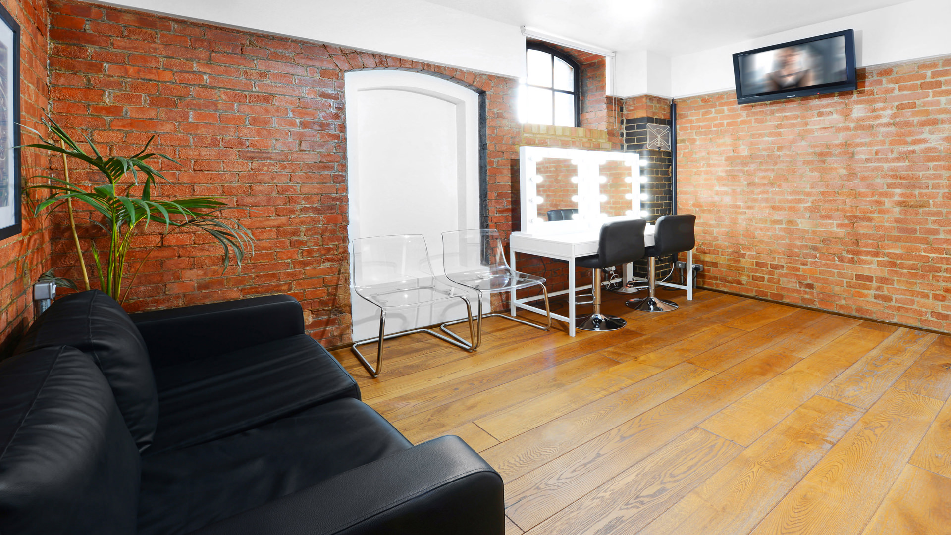 Stylish S1 Apartment event space with sleek vanity and exposed brick walls.