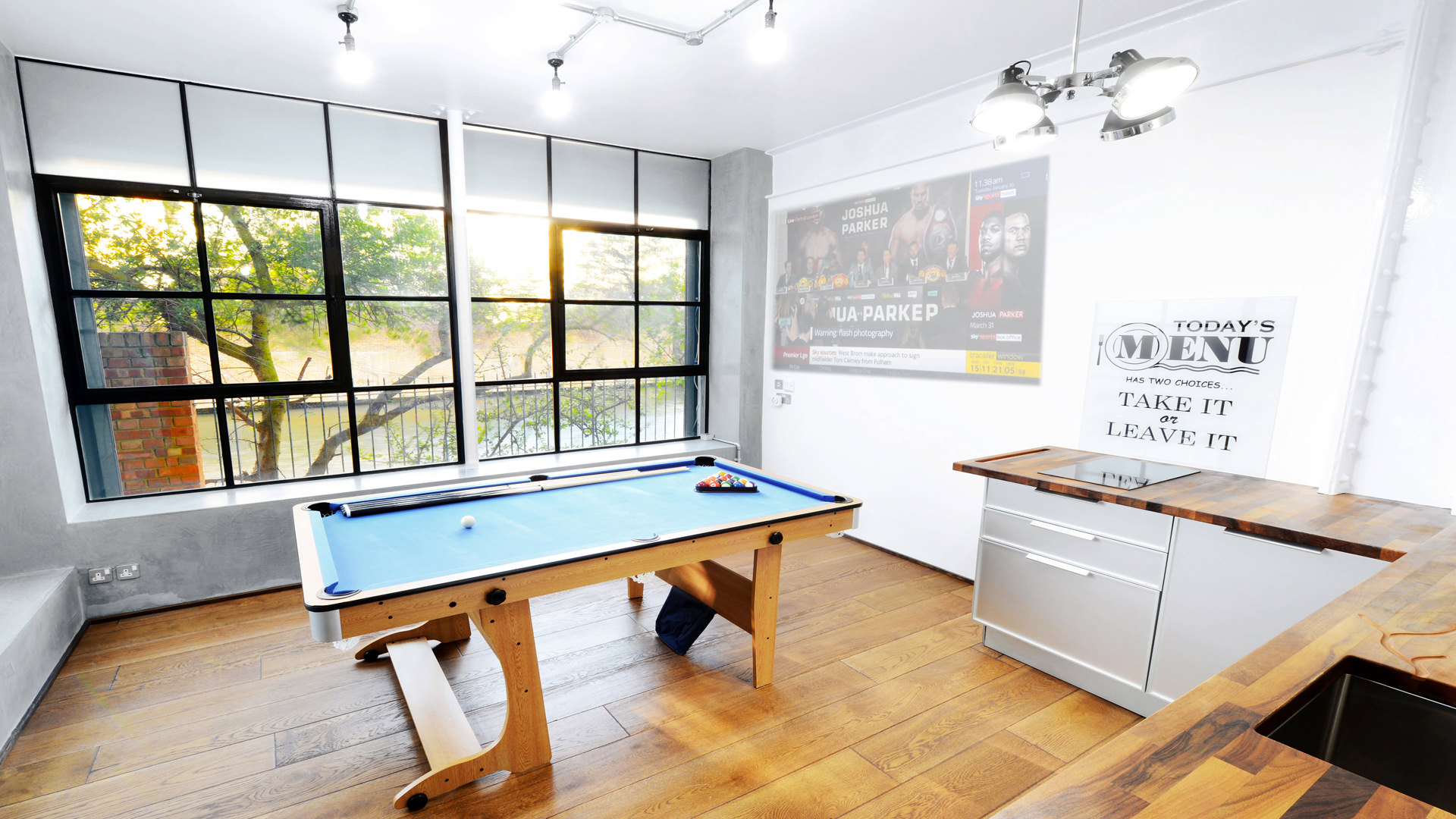 Versatile meeting space with pool table for team bonding in S1 Apartment.