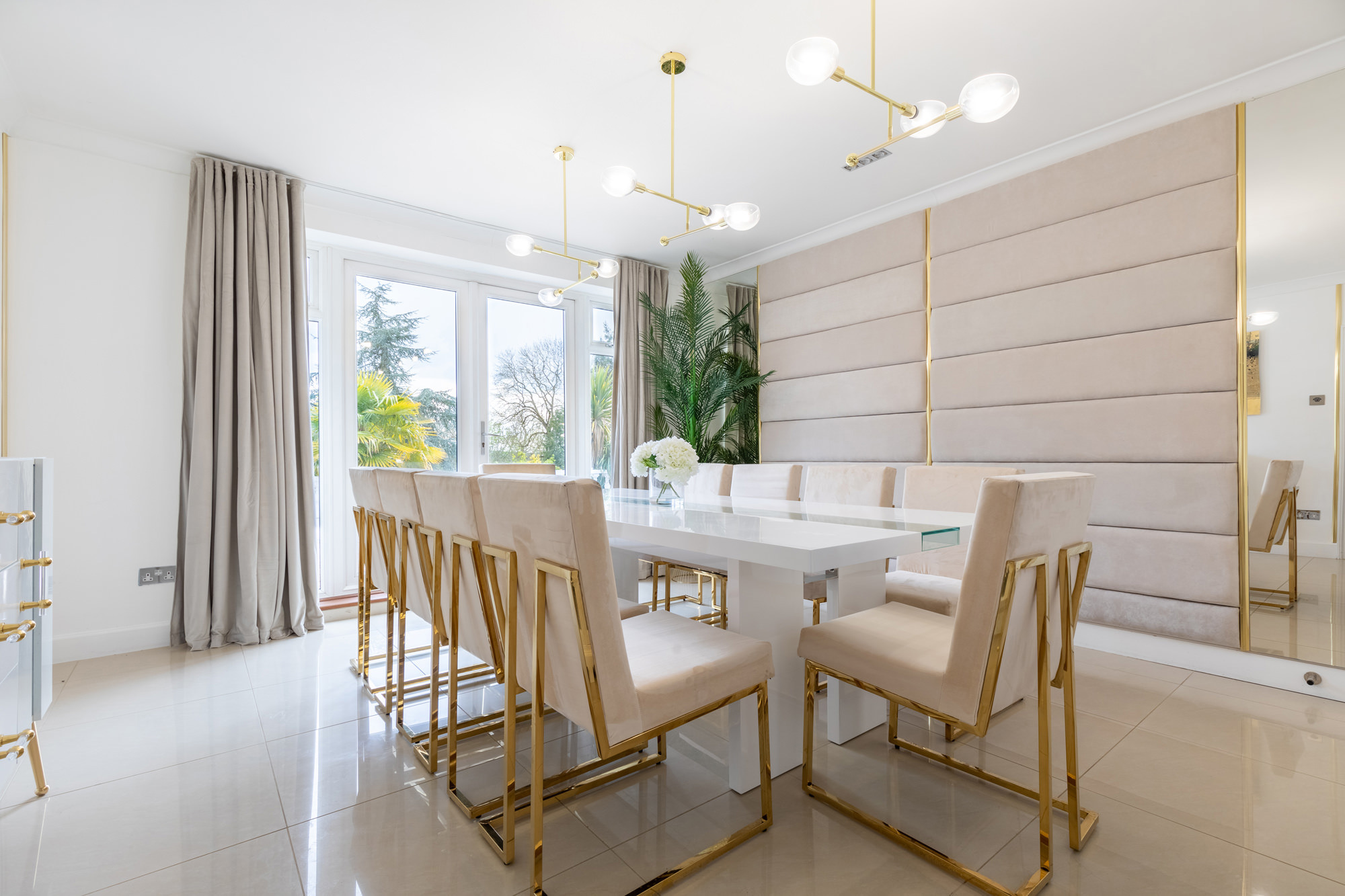 Modern meeting space at The Villa Mansion with elegant white table and stylish chairs.