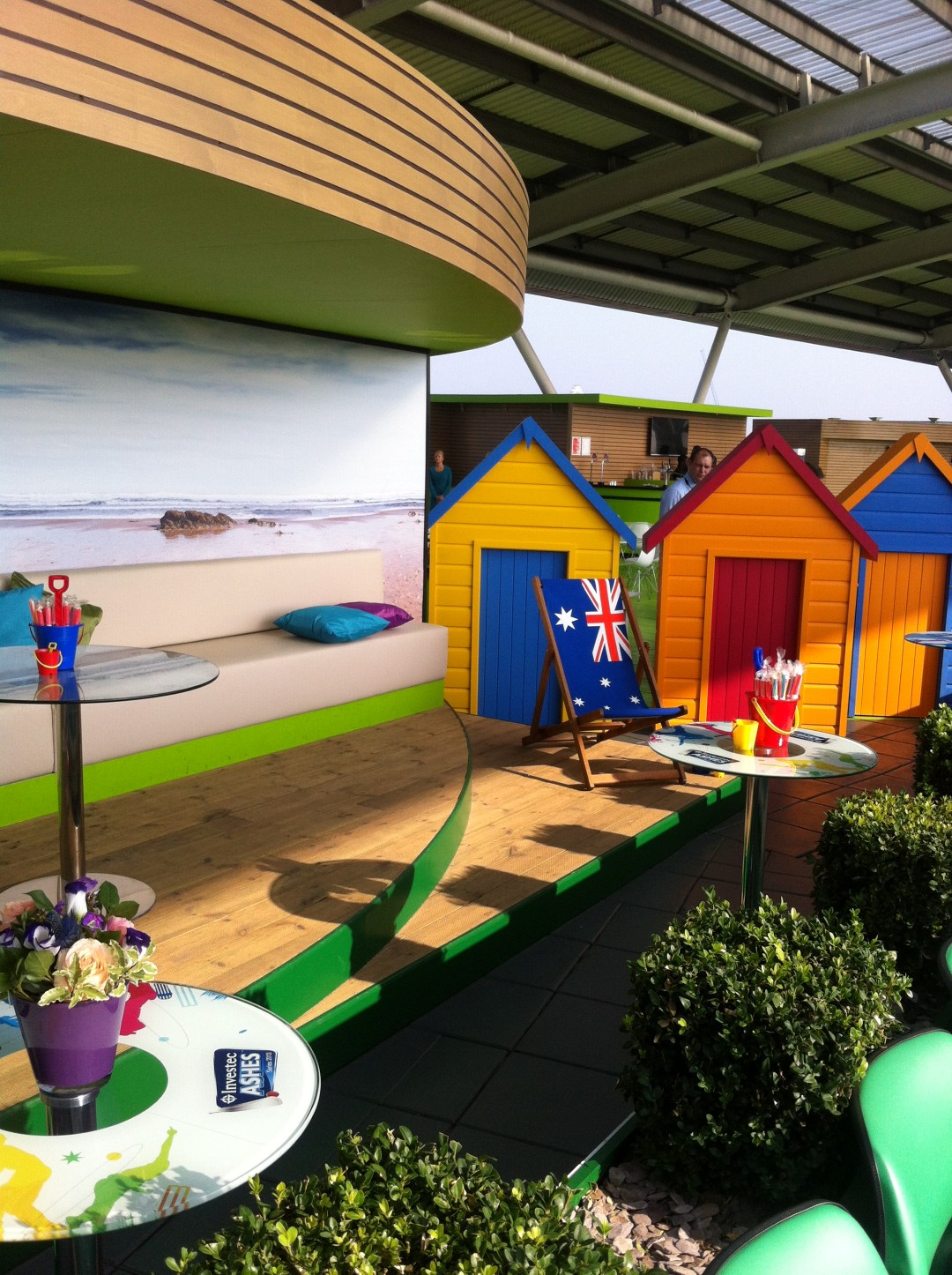Corinthian Roof Terrace at Kia Oval: vibrant beach-themed event space with colorful huts.