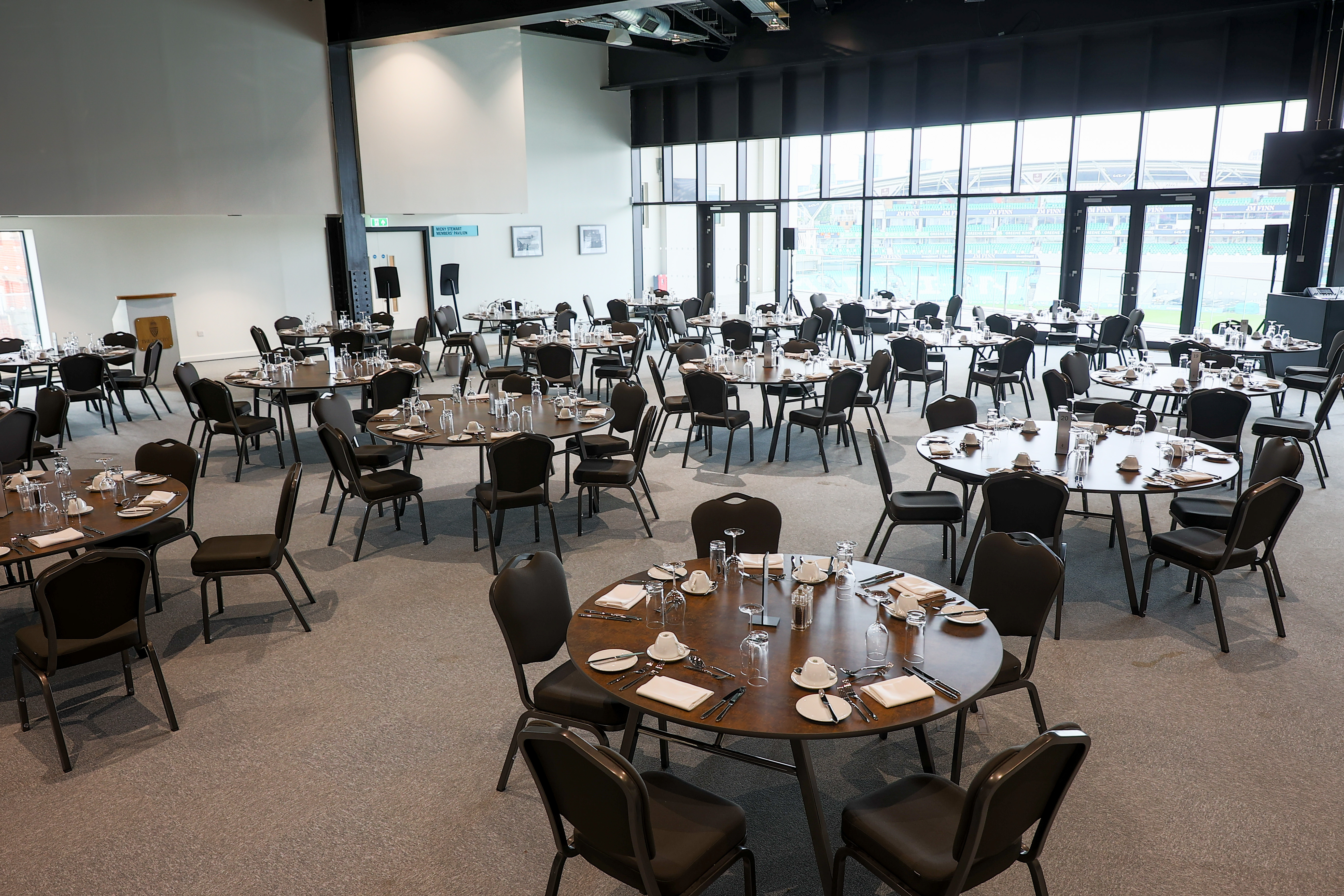 Duchy Suite at Kia Oval, spacious venue for corporate events with elegant round tables.