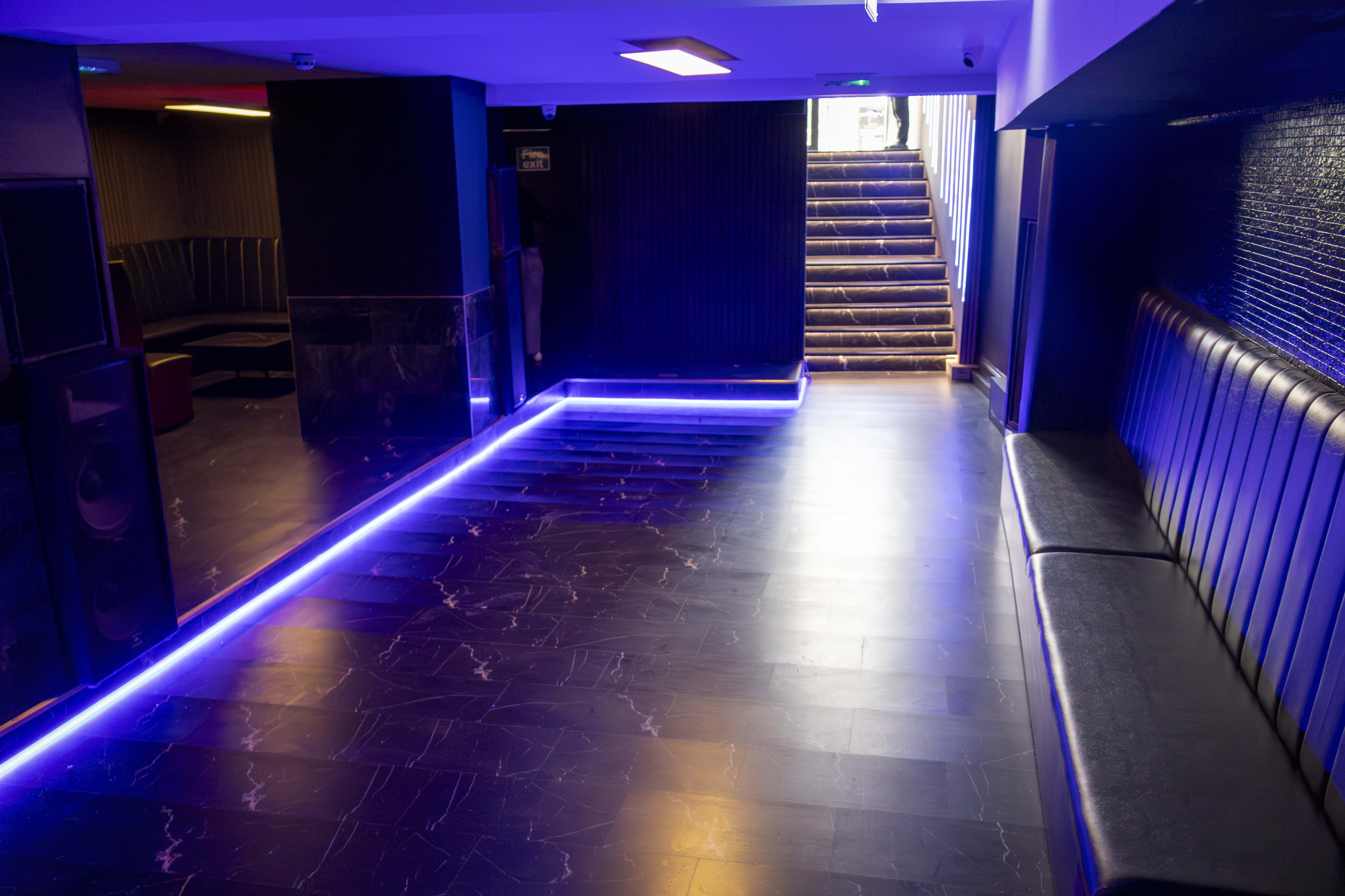Modern event space in Basement 144 with polished floors and ambient LED lighting.