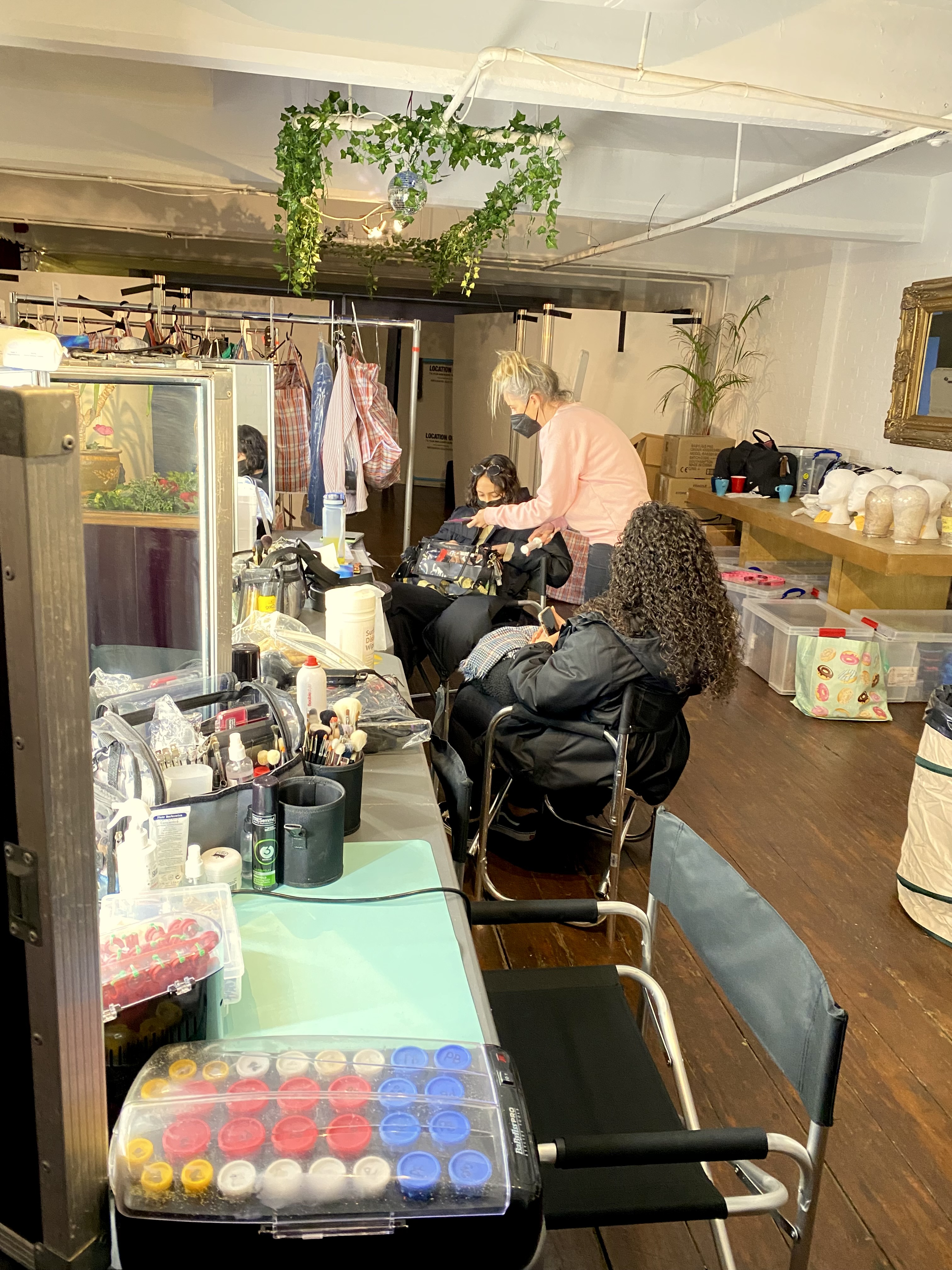 Behind-the-scenes event setup at 4th Floor Studios with hair and makeup tools.