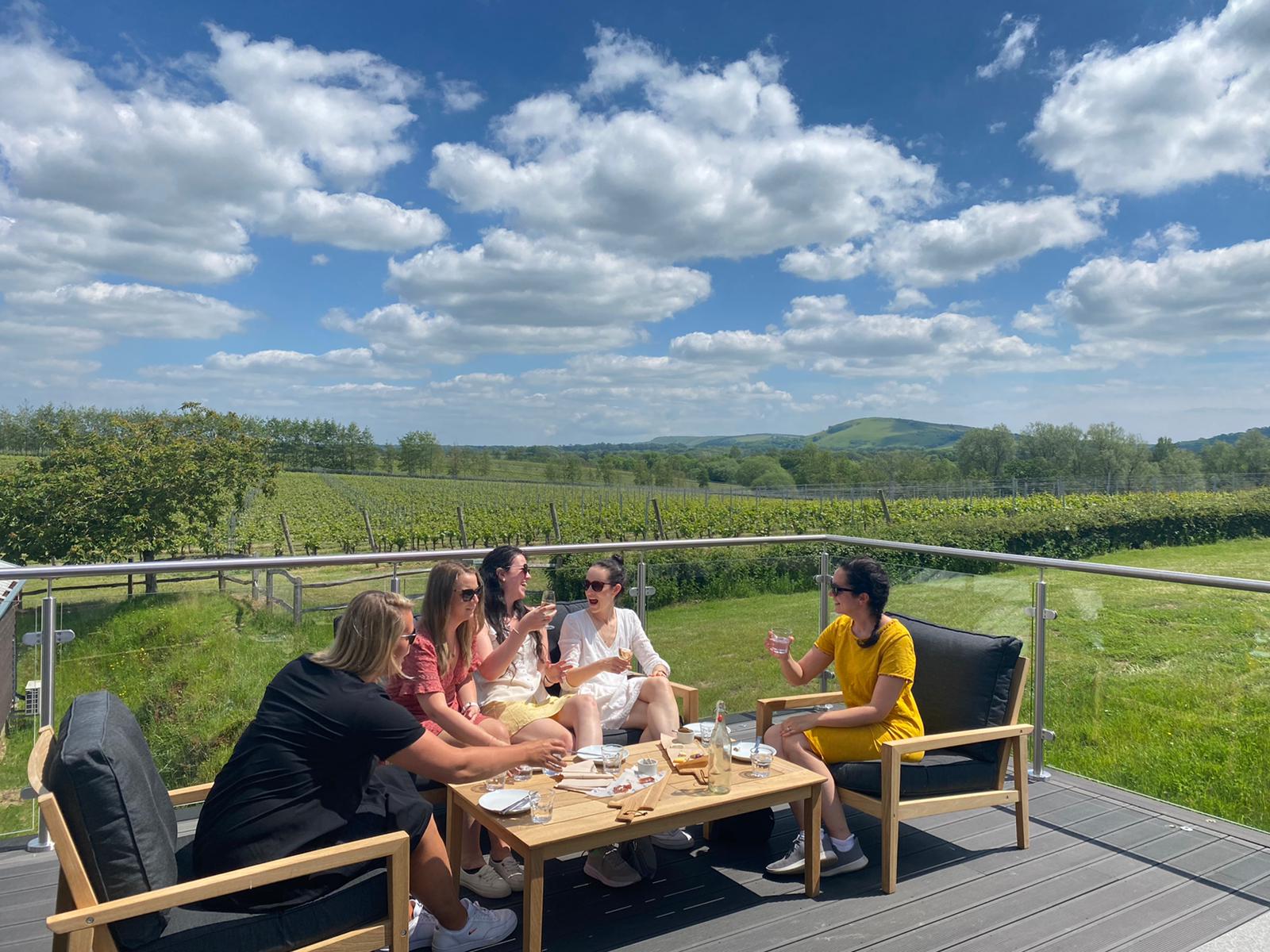 Outdoor corporate retreat at Albourne Estate with scenic vineyard backdrop.