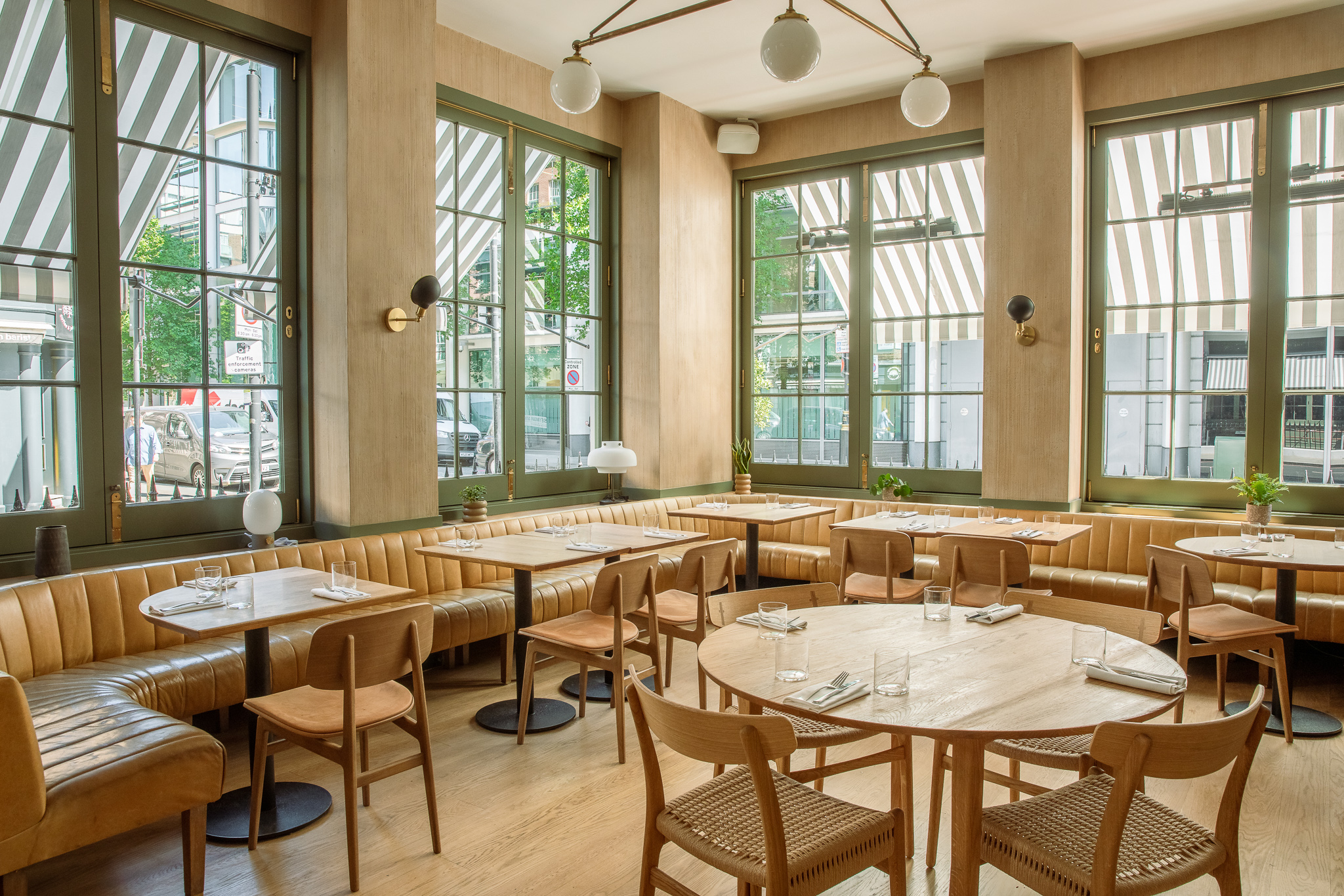Stylish restaurant interior with natural light, ideal for events and casual dining.