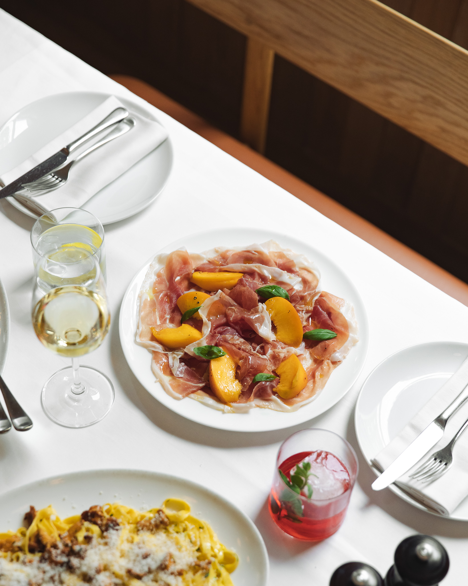 Elegant prosciutto plate with peaches for upscale events like weddings or galas.