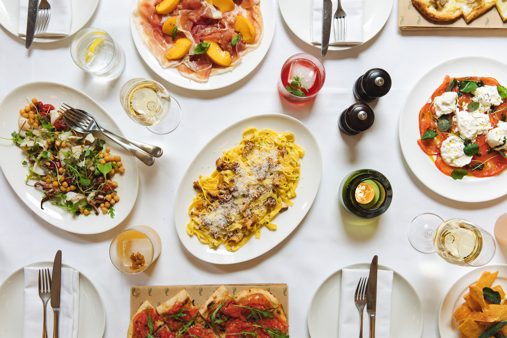 Elegant dining table with gourmet dishes for networking event at The Italian Greyhound.