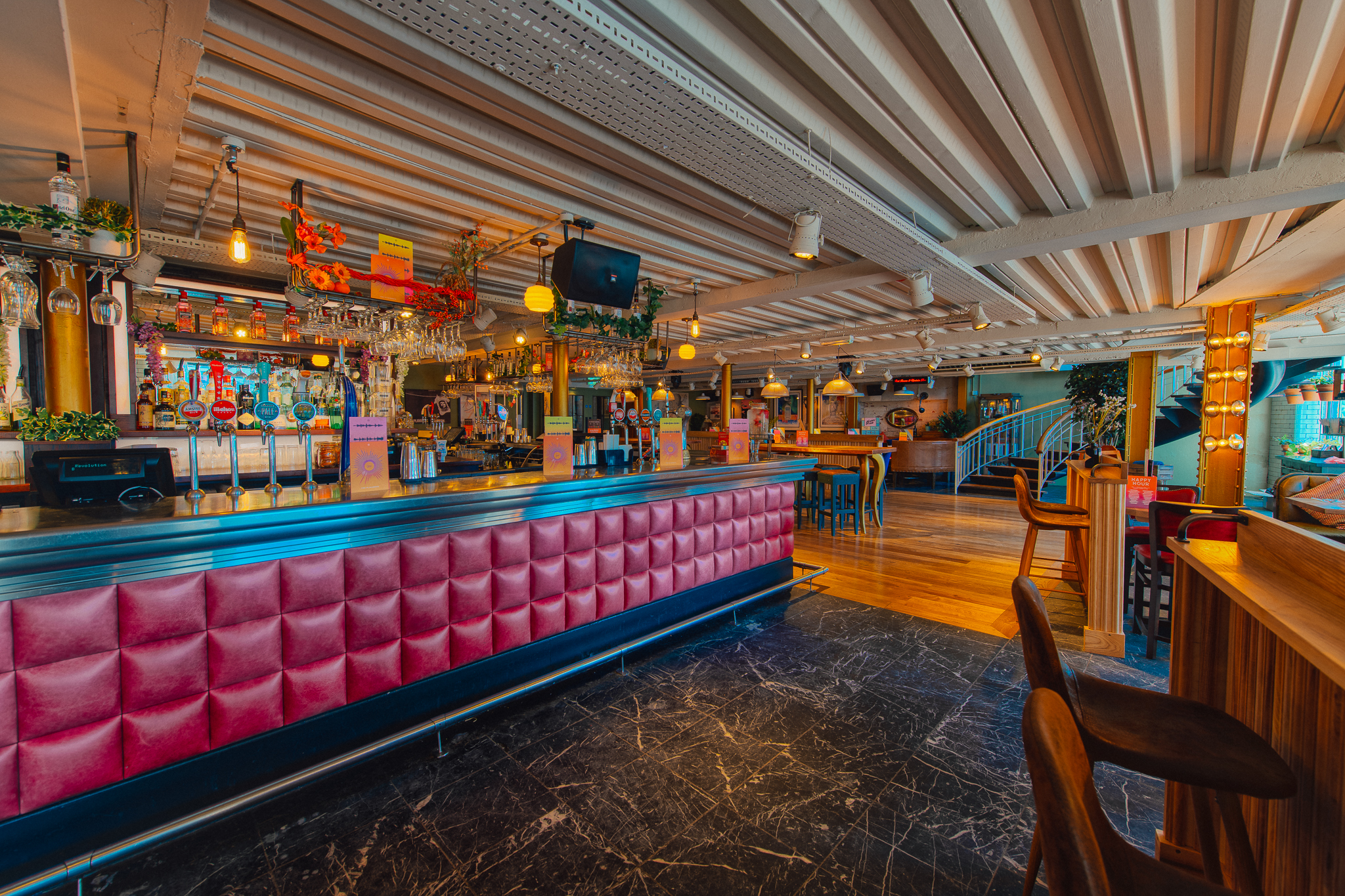 Vibrant venue hire in Revolution York with stylish bar for events and gatherings.