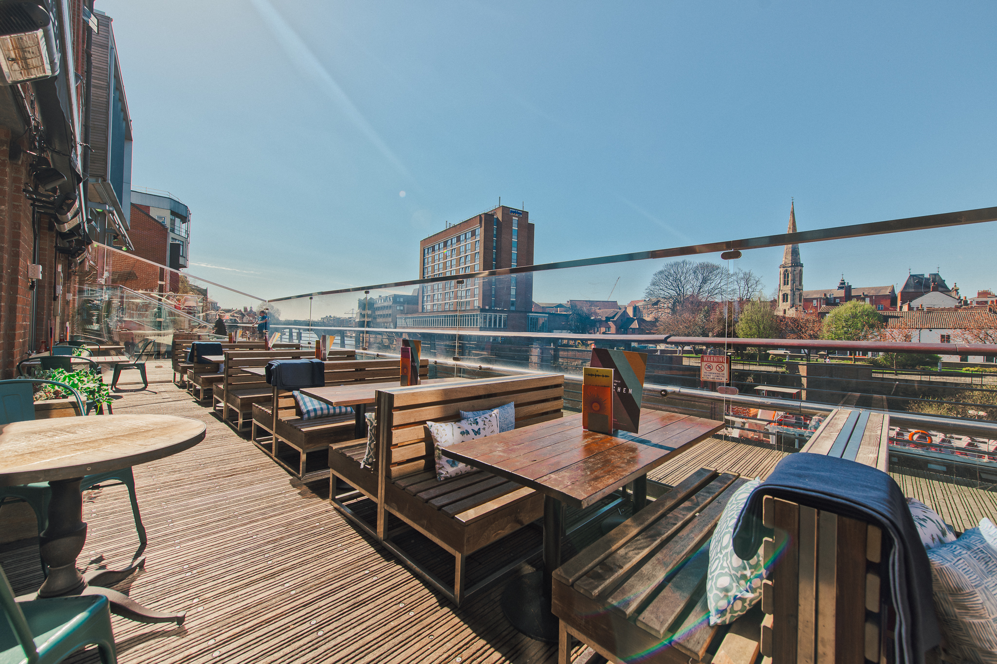 Vibrant outdoor venue with wooden seating at Revolution York for casual meetings and events.