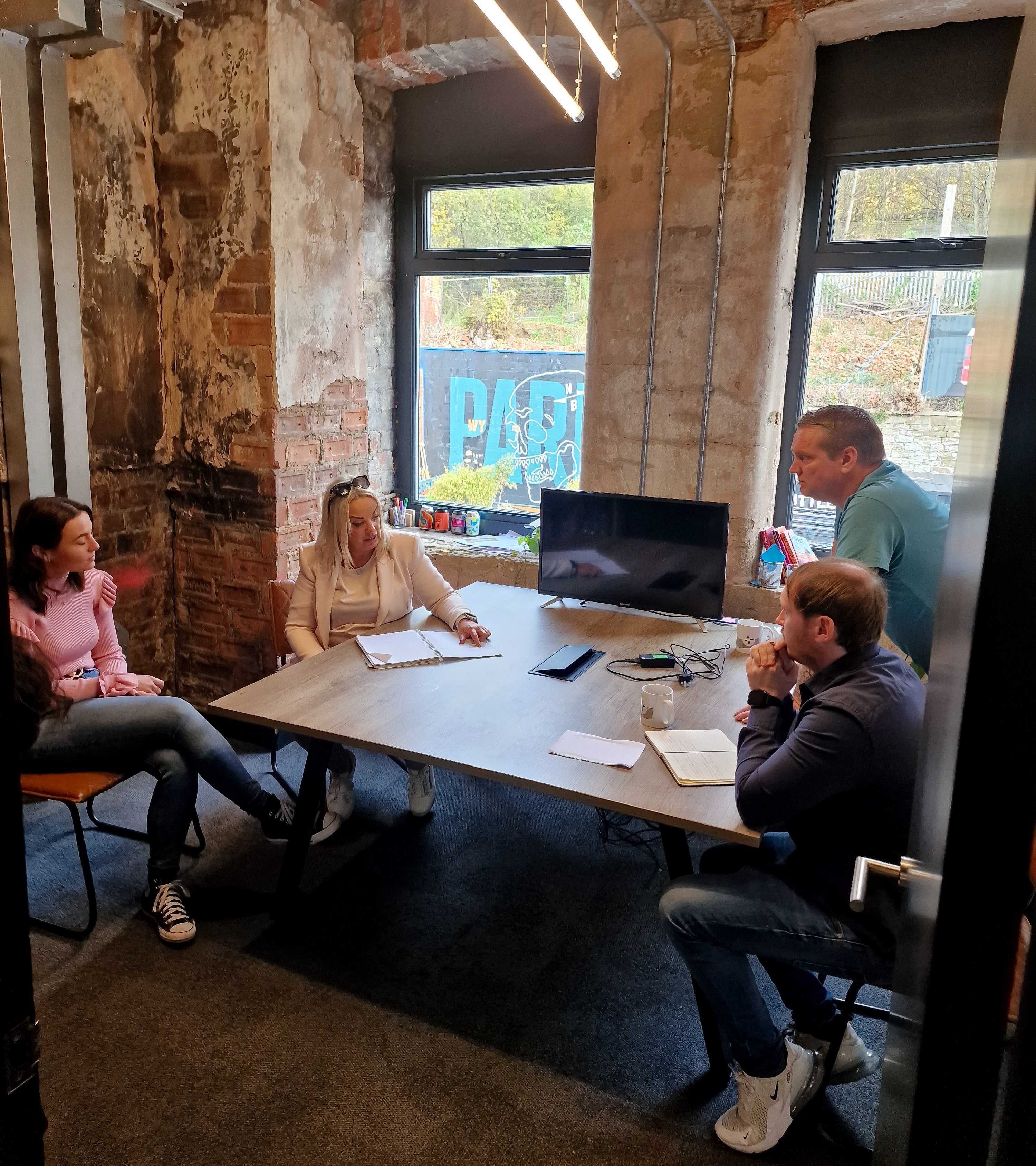 Collaborative meeting at North Brewing Co, featuring modern industrial design and teamwork.