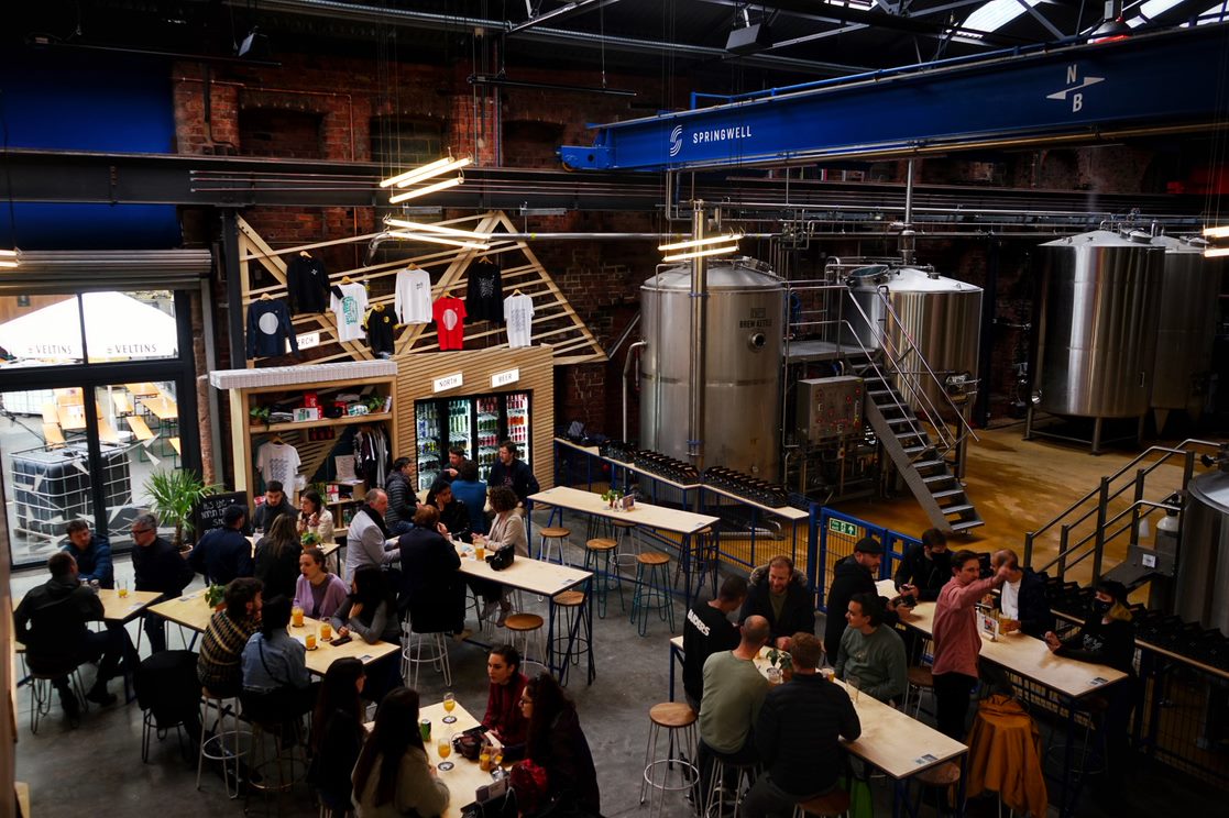 "Springwell Tap brewery event space with communal seating for team-building and mixers."