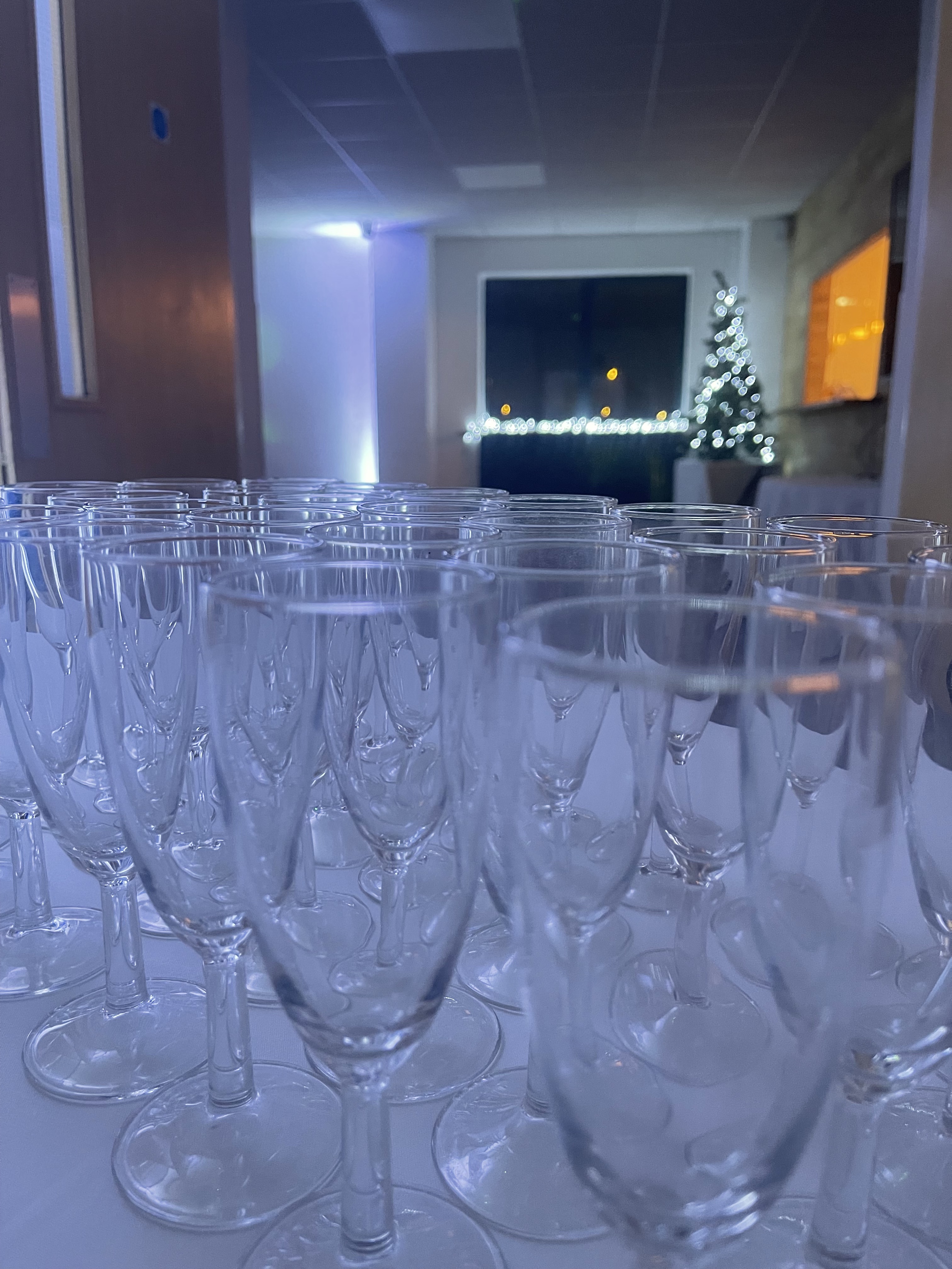 Elegant Waterside Suite with clear glasses, perfect for networking or celebration events.