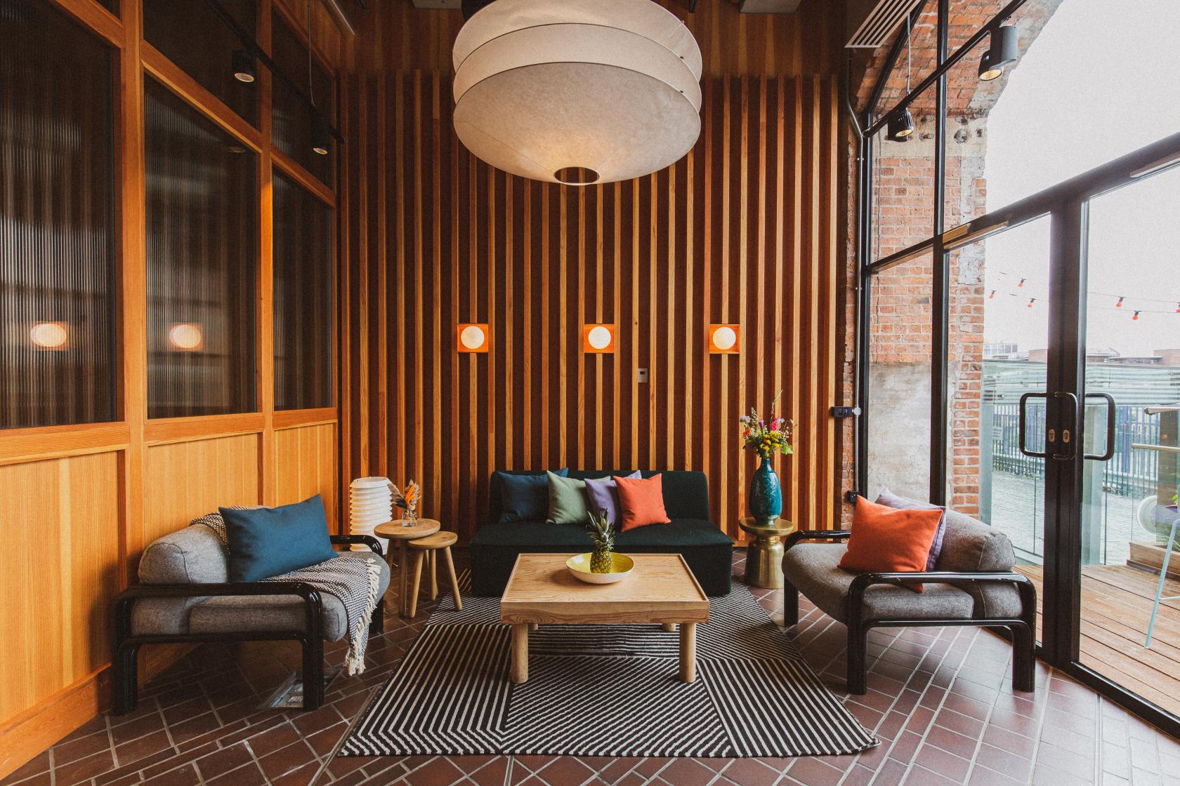 Stylish lounge area with wood paneling for networking events and informal meetings.