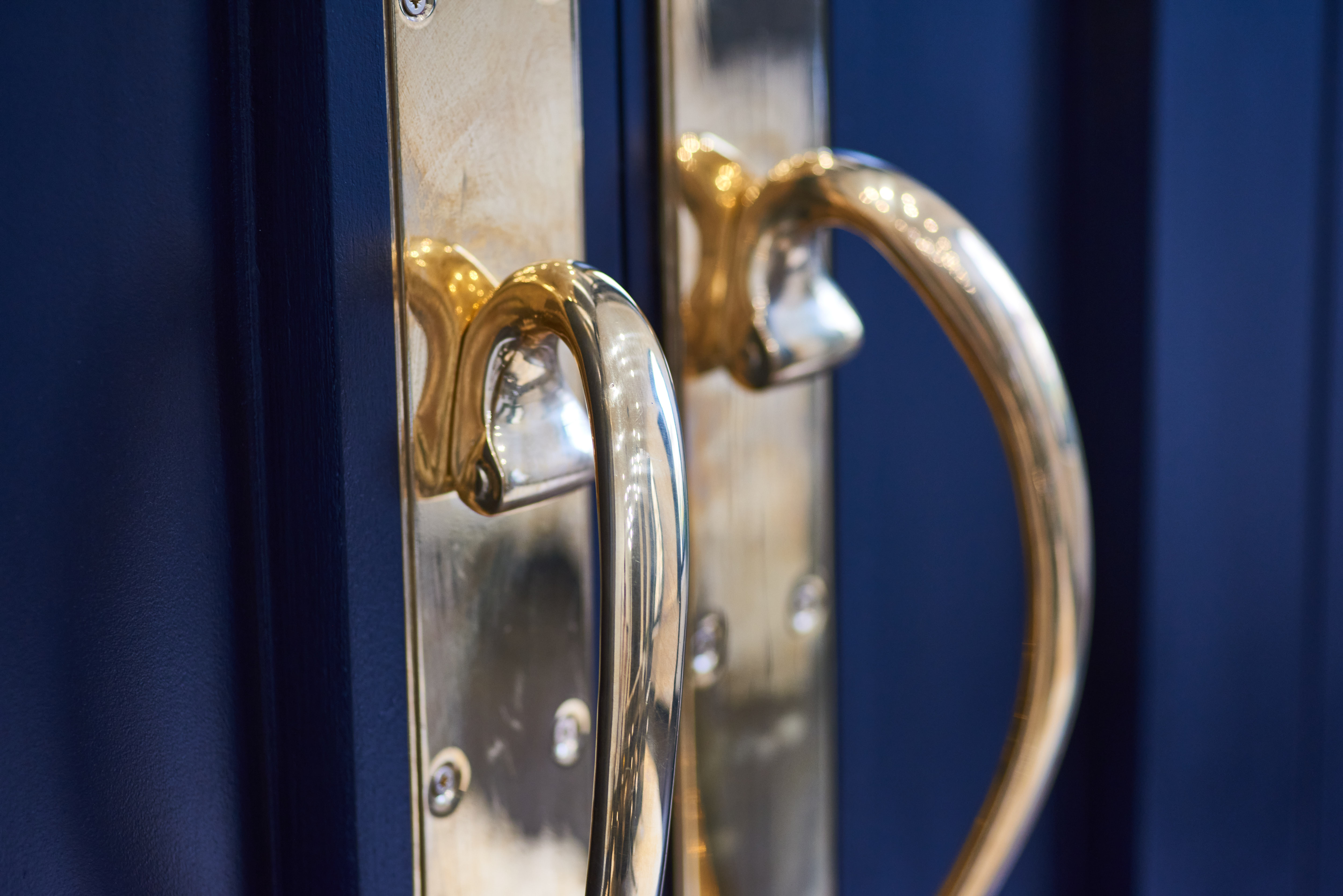 Elegant brass door handles on a blue door at George House Business Centre event venue.