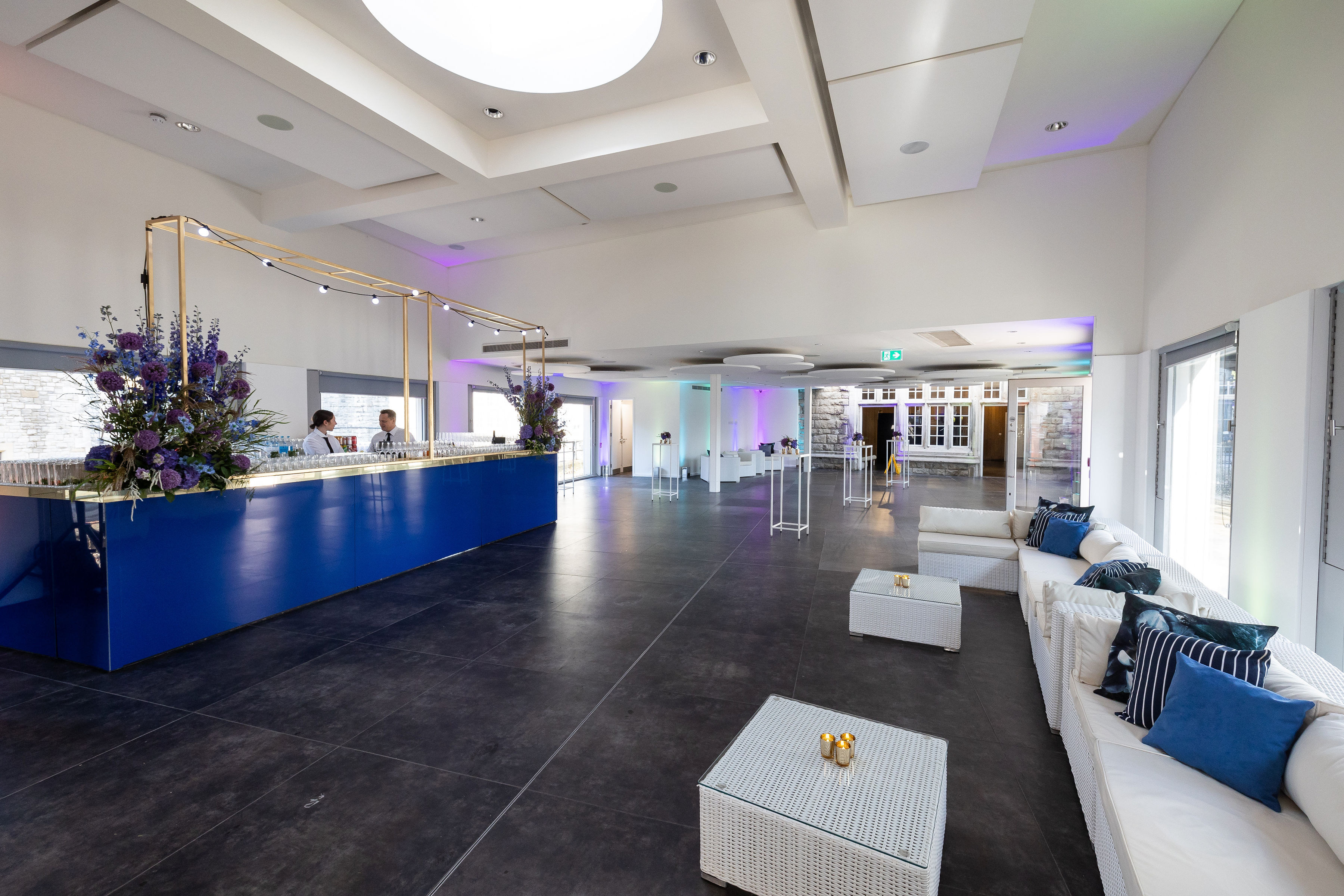 Modern event space at HM Tower of London with sleek blue reception and stylish seating.