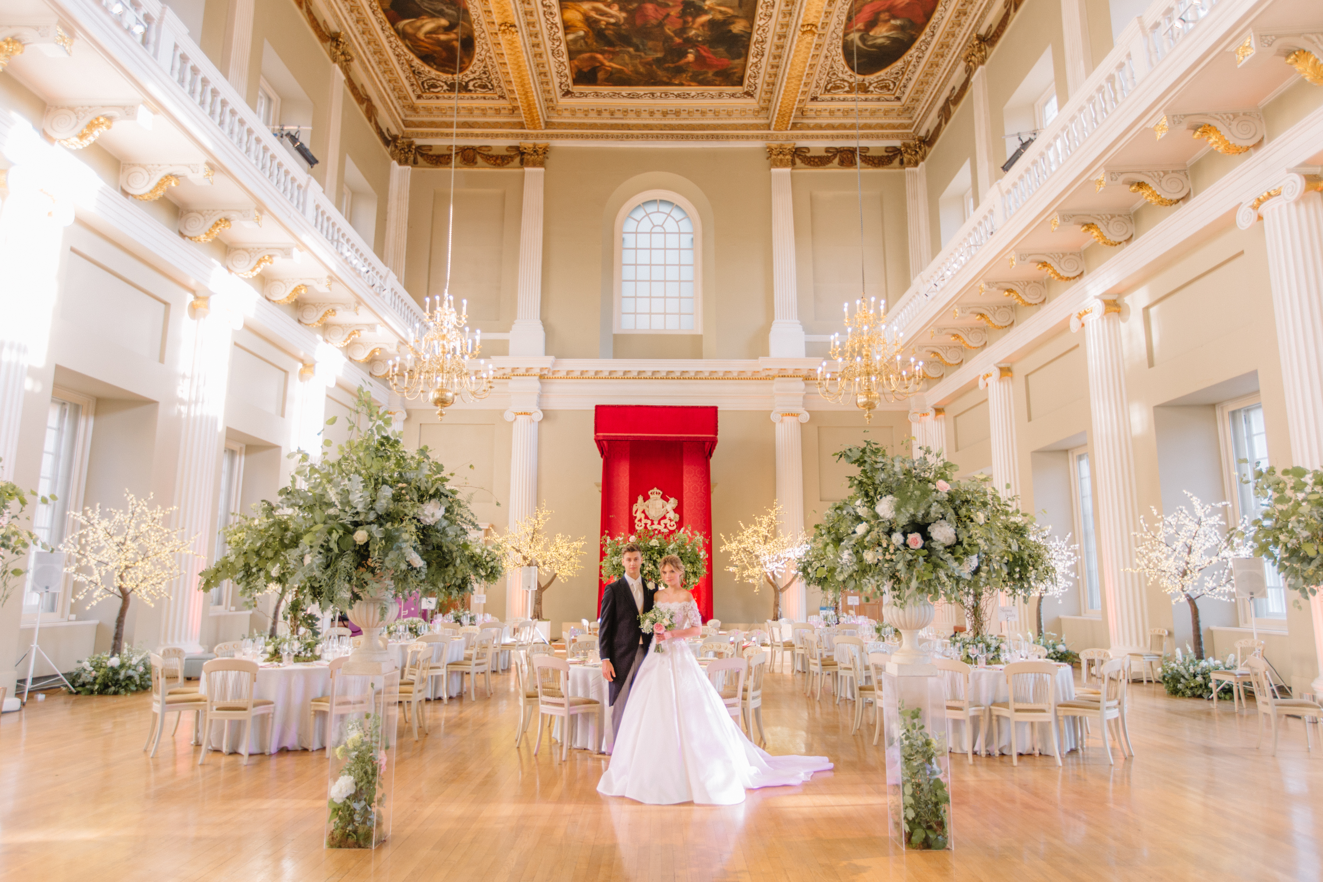 Elegant wedding venue with high ceilings and floral decor in Banqueting House.
