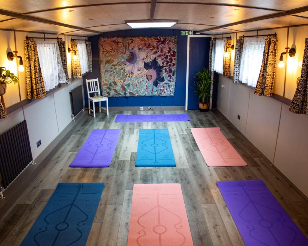 Serene yoga space with colorful mats, ideal for wellness retreats and mindfulness workshops.