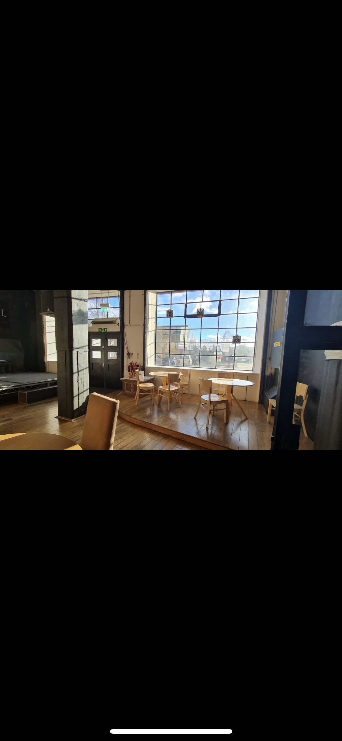 Spacious MAAD venue with large windows, ideal for events and presentations.