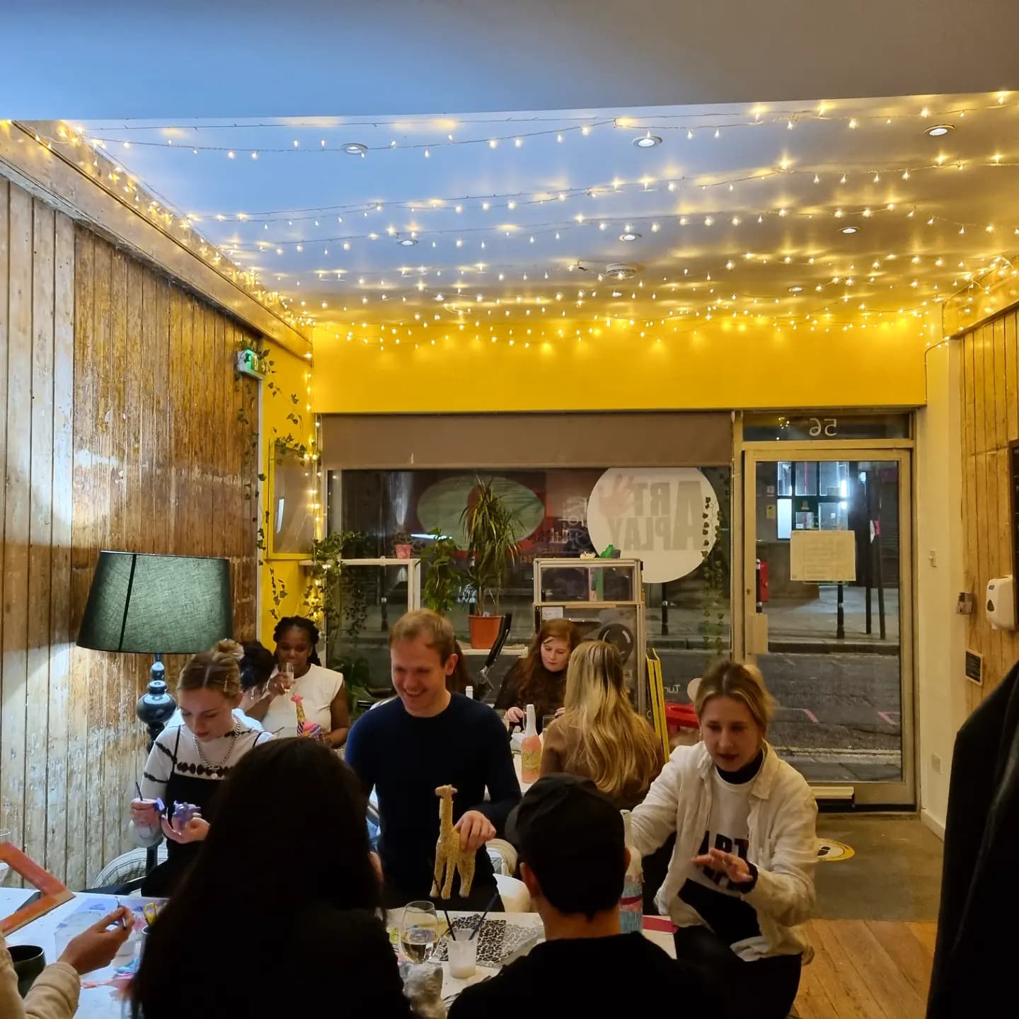 Vibrant pop-up space with engaged attendees at a social networking event.