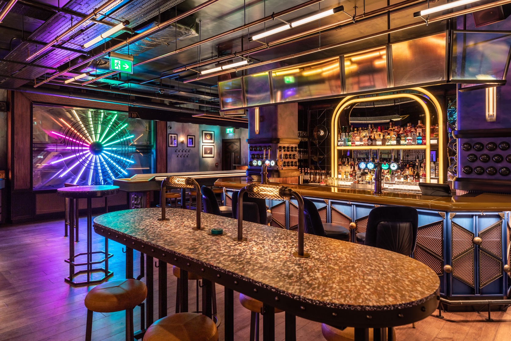 Vibrant event space at The Biberdorf, stylish bar with colorful lighting for gatherings.