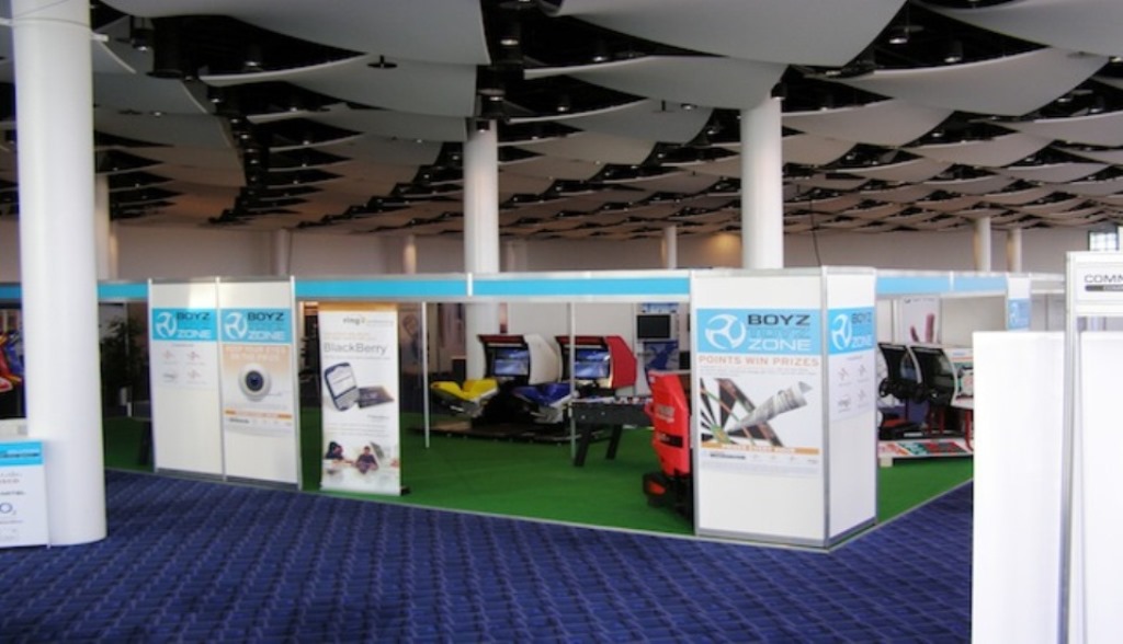 Wembley Stadium Great Hall exhibition with vendor booths and vibrant branding.
