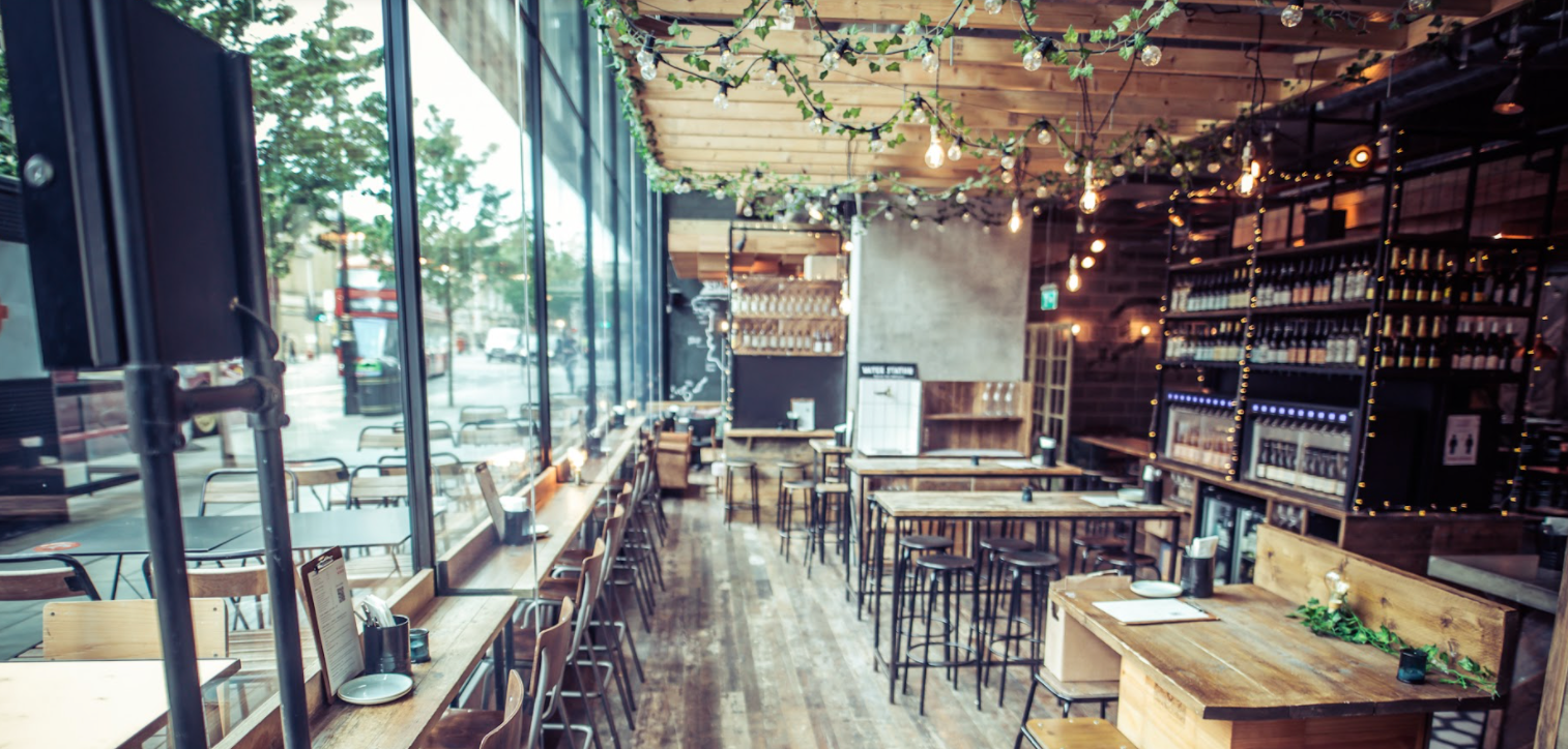 Royal box in Vagabond Victoria, modern venue with wooden tables for meetings and events.