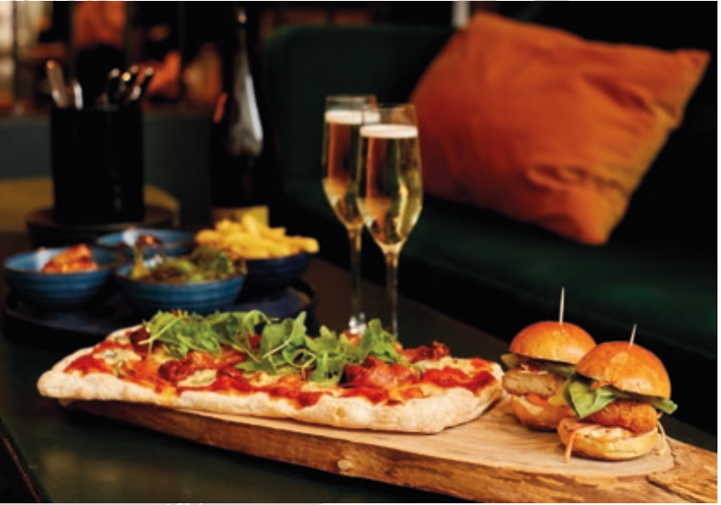 Royal box catering setup with gourmet pizza for casual networking event.