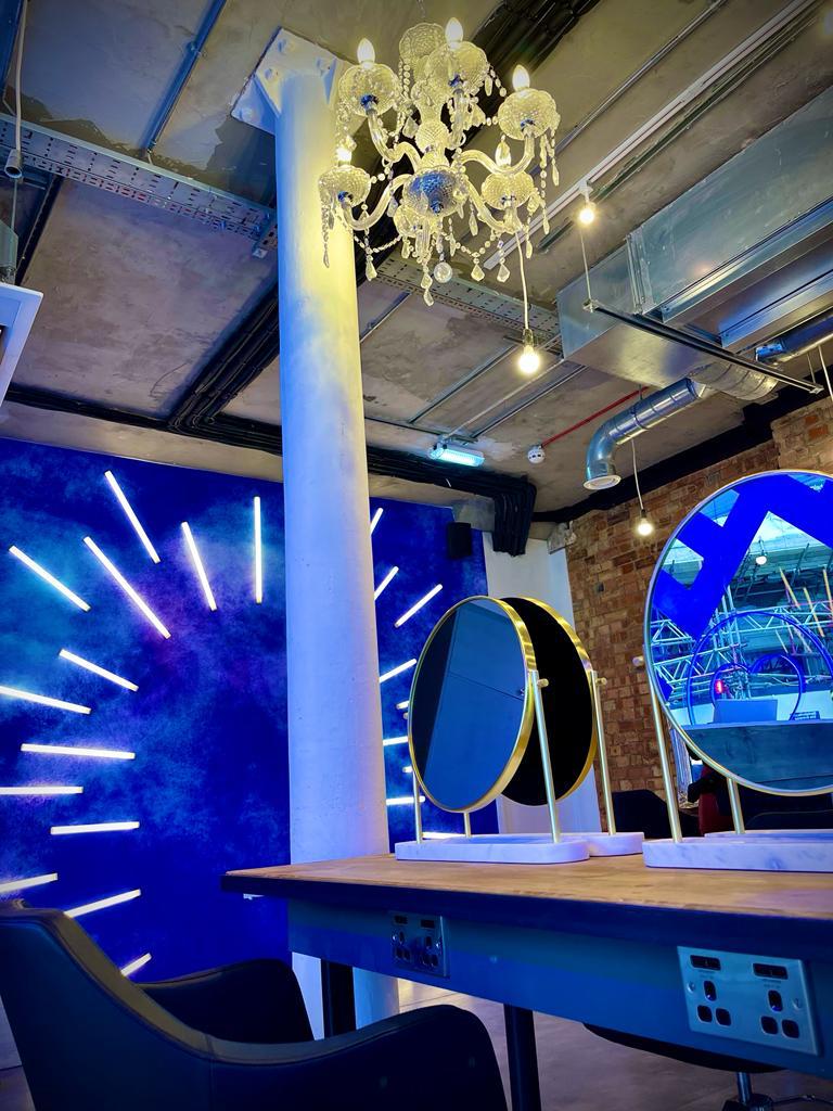 Modern event space at Live True Soho with vibrant lighting and elegant circular mirrors.