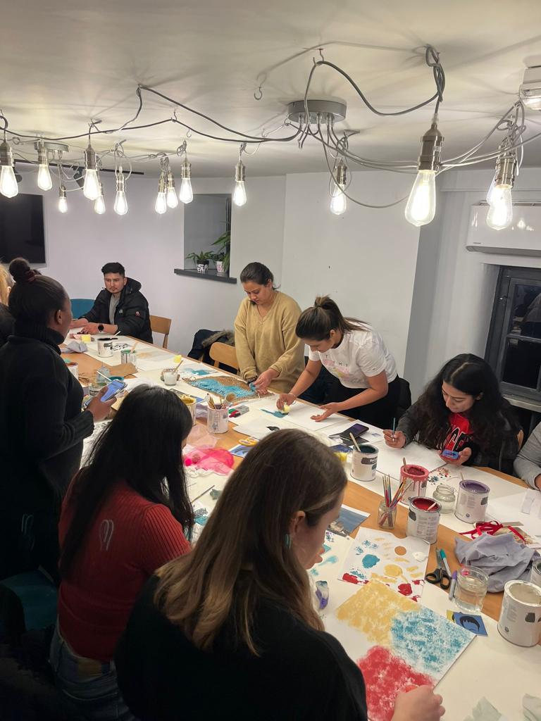 Creative workshop at MerseyMade with participants engaged in hands-on painting activity.