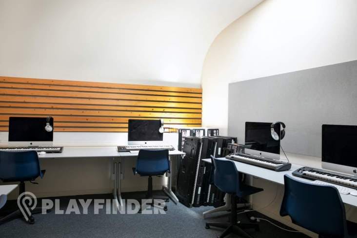 Modern music room at St Aloysius' College with computer stations for tech workshops.