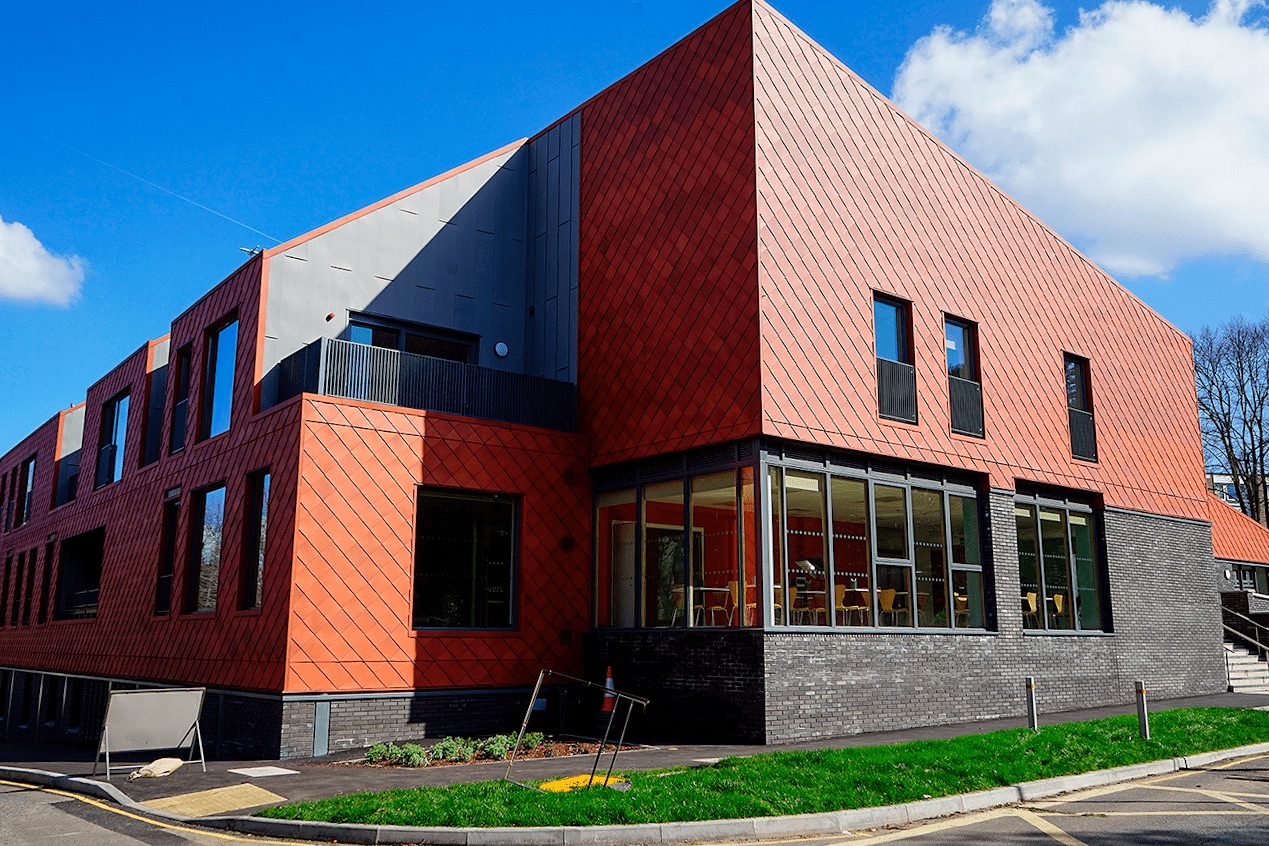 Modern Hive Cafe with large windows, perfect for meetings and workshops.