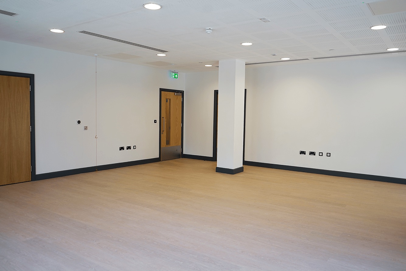 Versatile meeting space at Hive Cafe with natural light for workshops and corporate events.