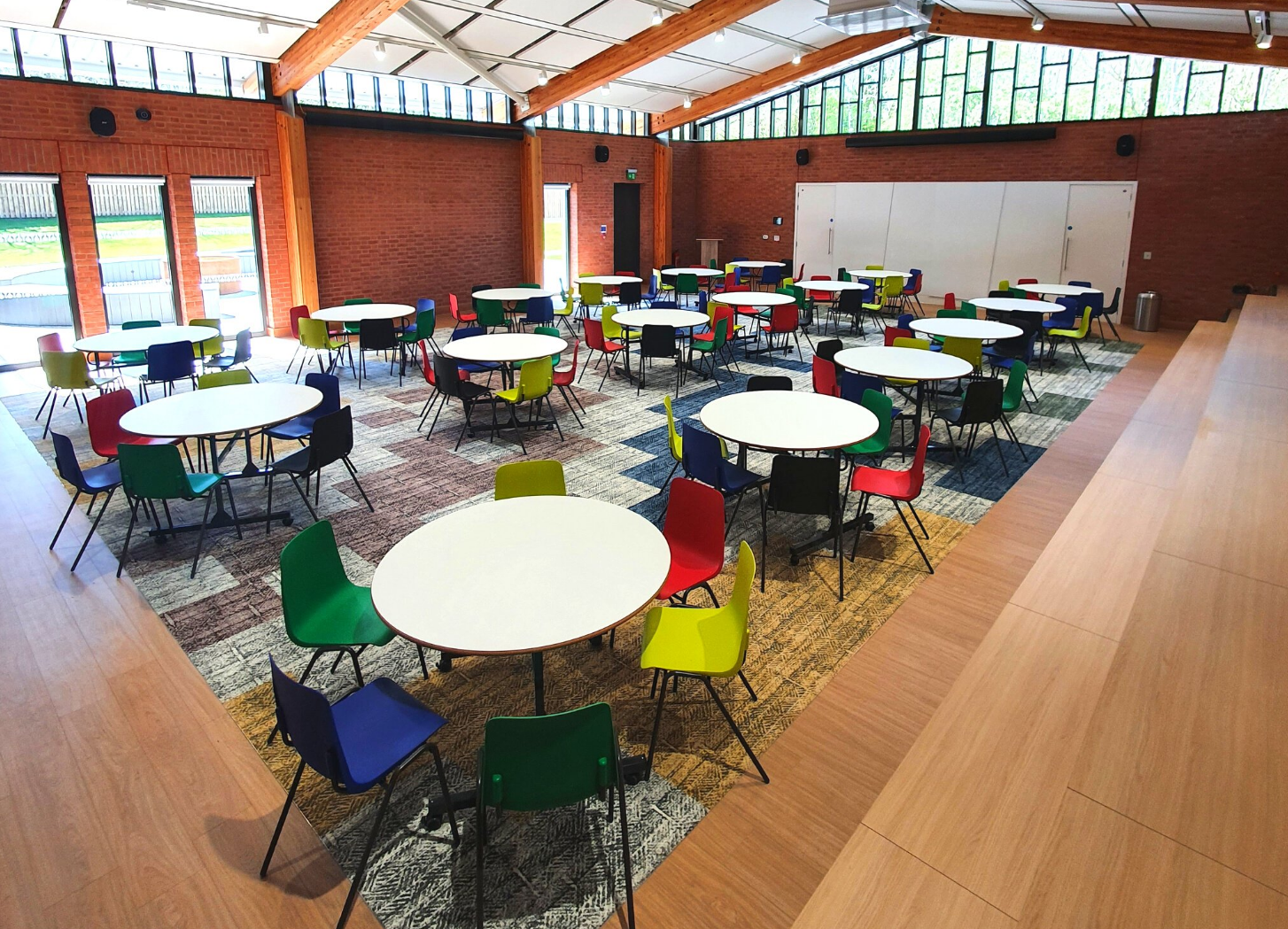 Ollerenshaw Room: versatile event space with round tables, ideal for workshops and networking.