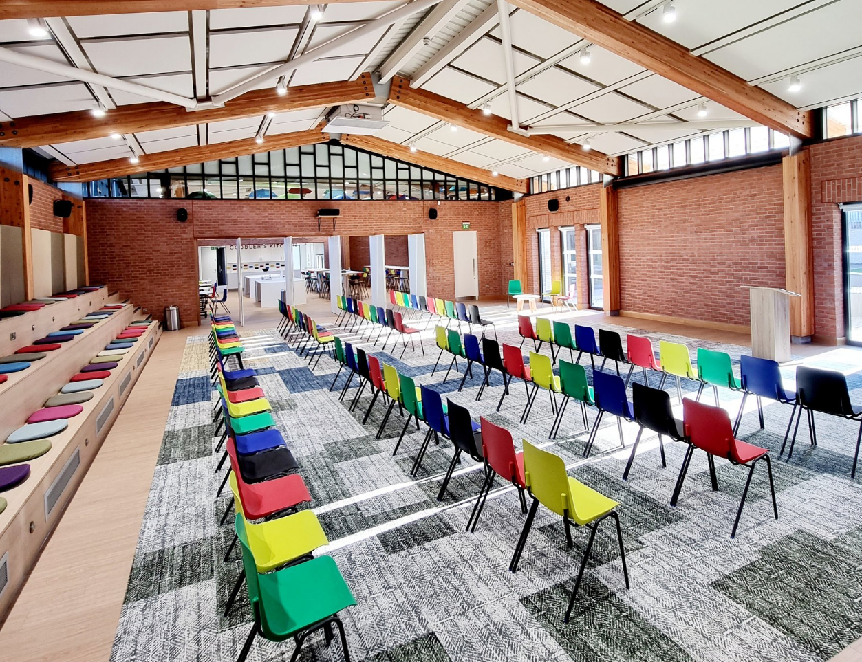 Ollerenshaw Room: versatile event space with colorful chairs for workshops and presentations.