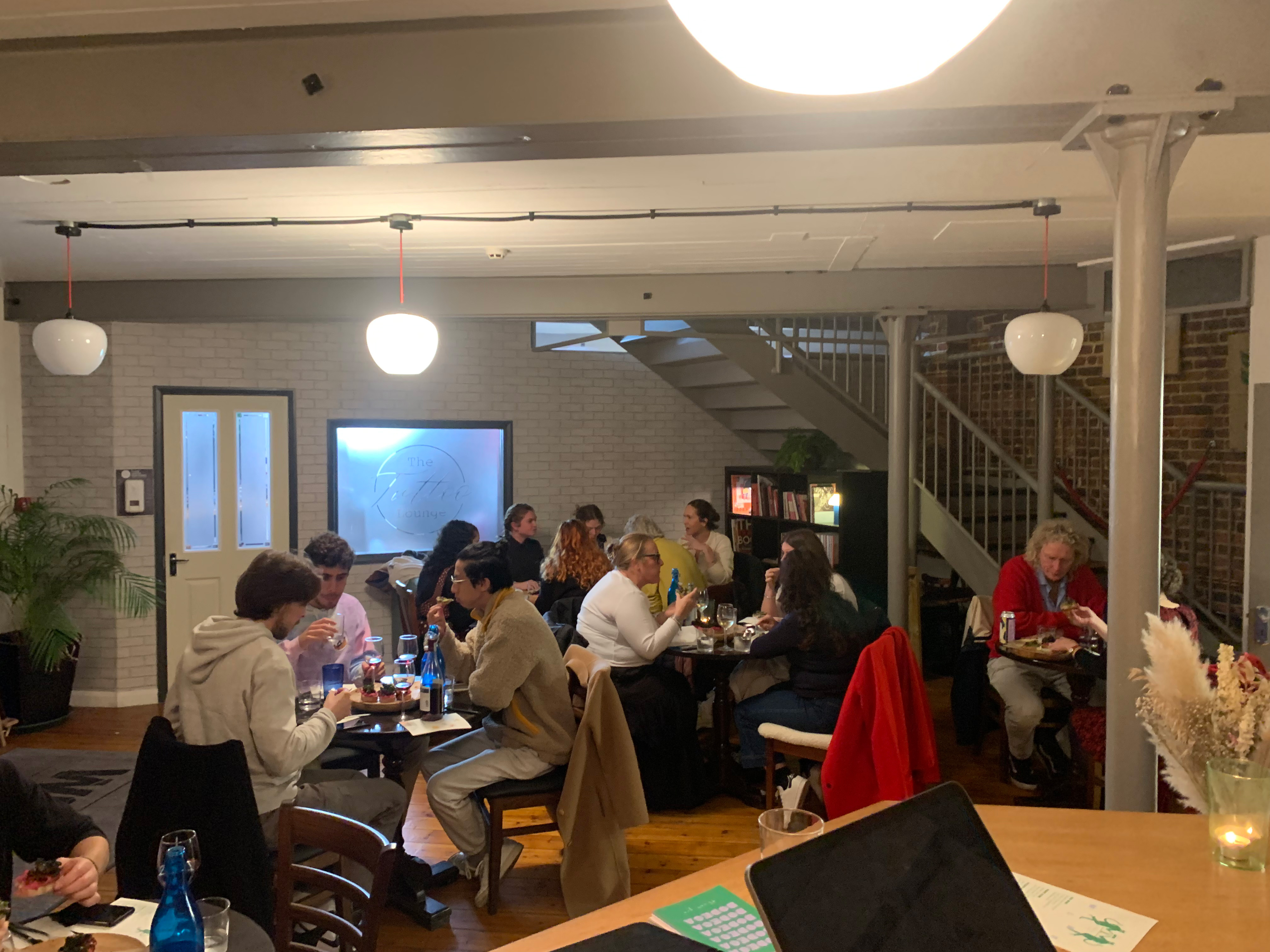 "Intimate networking event at Bodega Eastbourne with warm lighting and stylish decor."