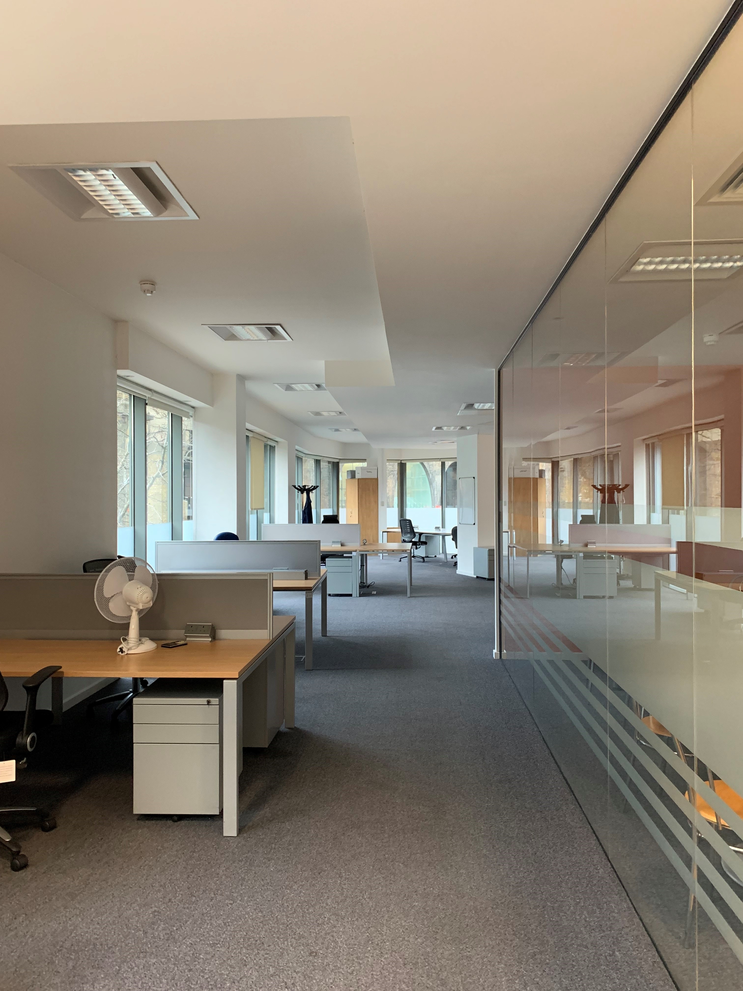 Modern open office space with natural light for meetings and workshops.