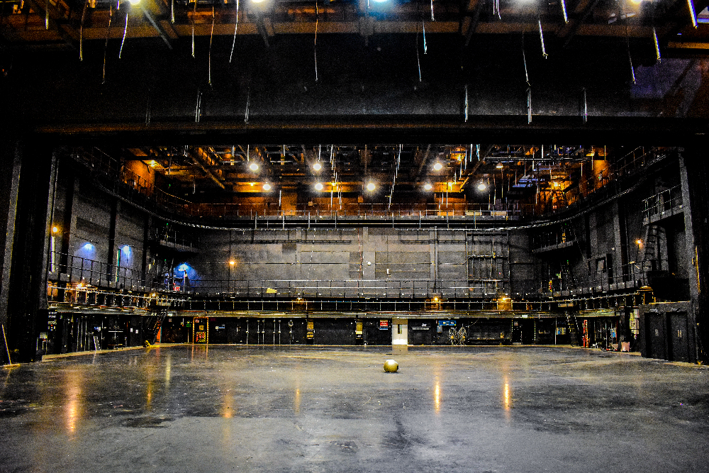 Spacious Troubadour Wembley Park Theatre stage with intricate lighting for events.