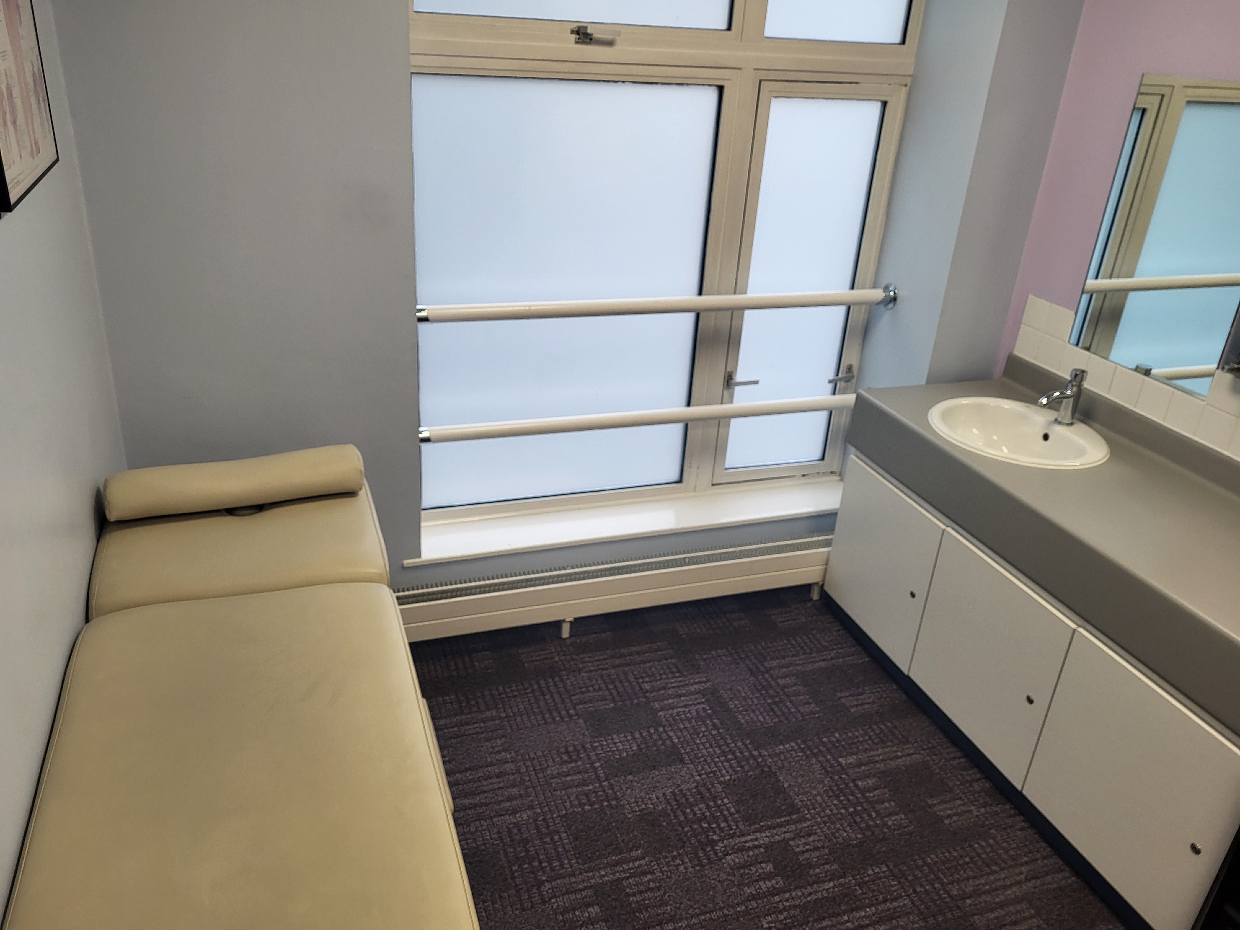 Treatment room at Queen Mary University, minimalist design for wellness and private meetings.