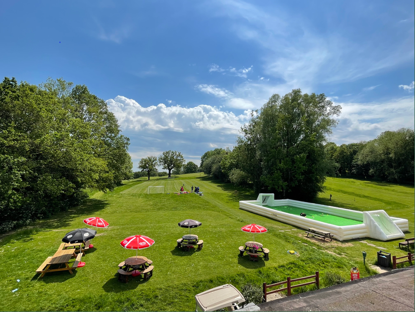 Outdoor venue at Horsenden Hill Activity Centre with green lawn for summer events.