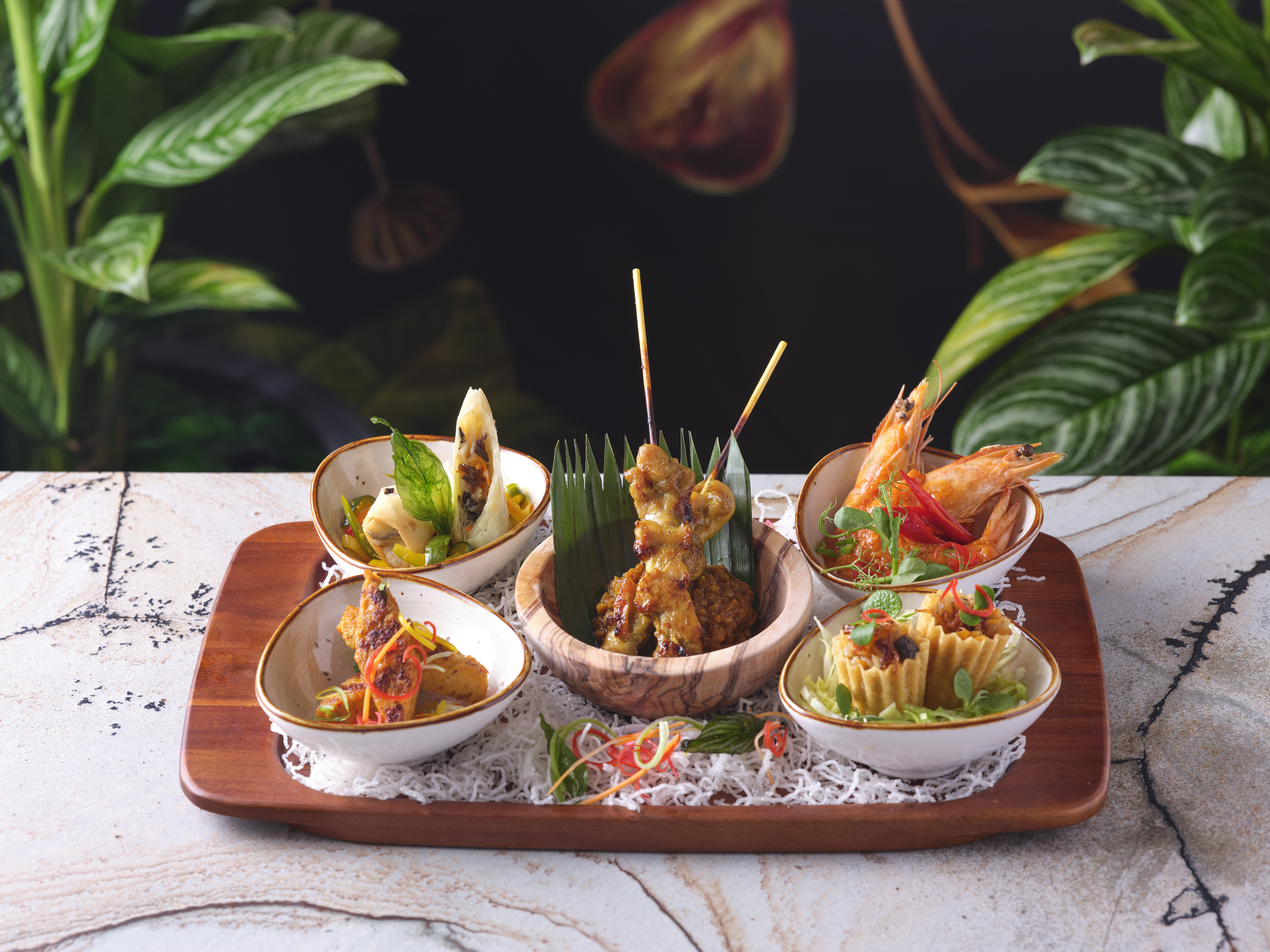 Gourmet appetizers on a wooden platter for upscale events and networking receptions.
