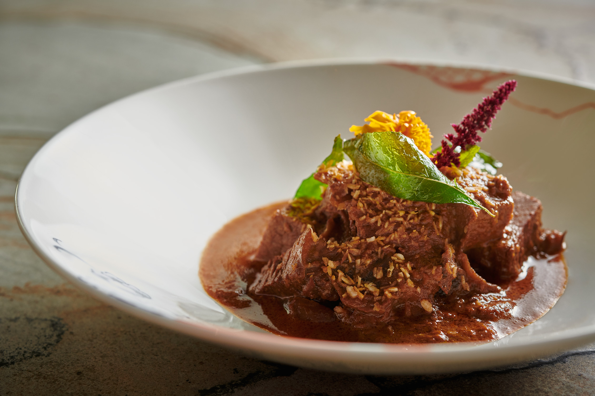 Gourmet dish at Straits Kitchen, vibrant presentation for upscale dining events.