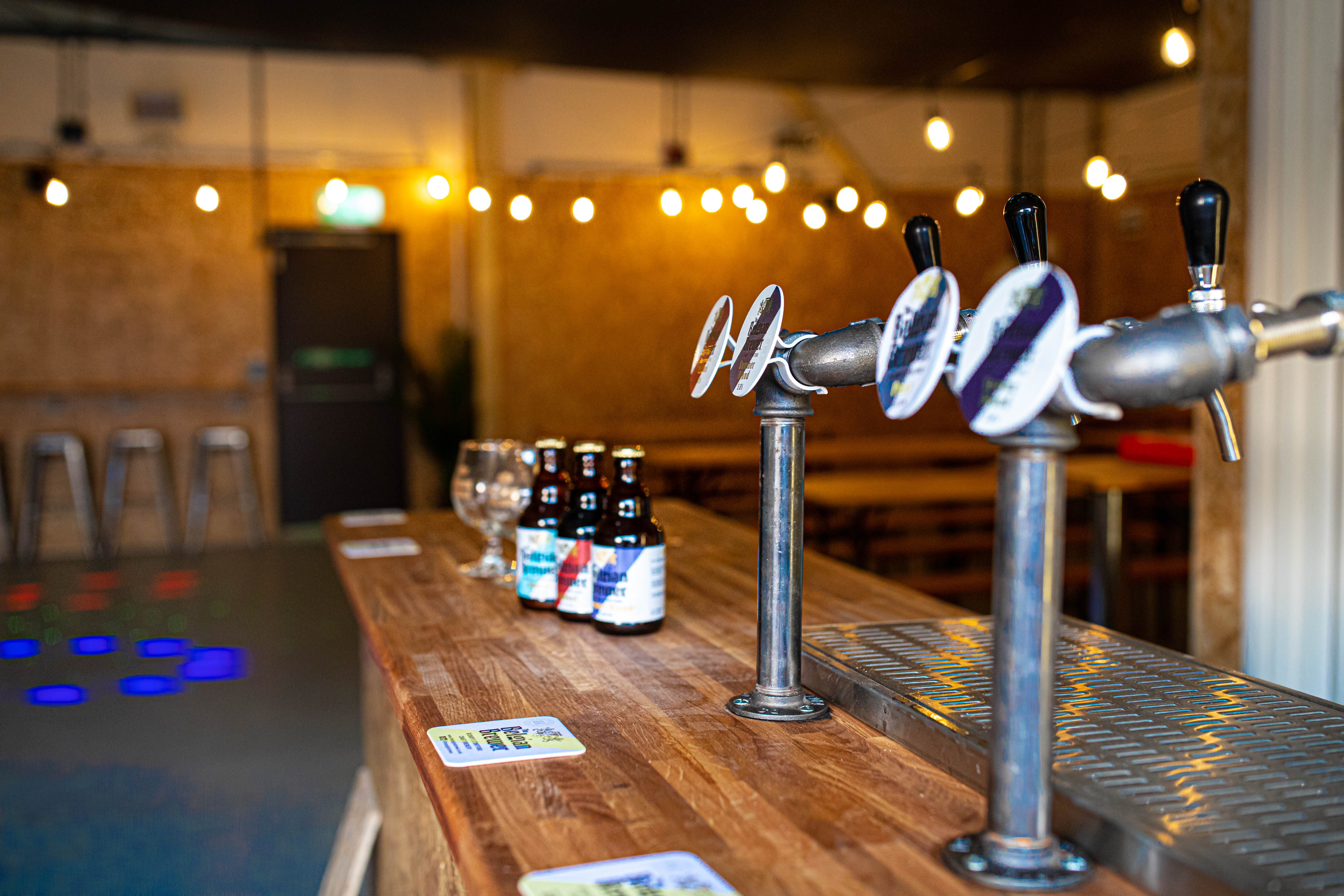 Stylish bar setup with sleek taps at The Belgian Brewer Event Hall for social gatherings.